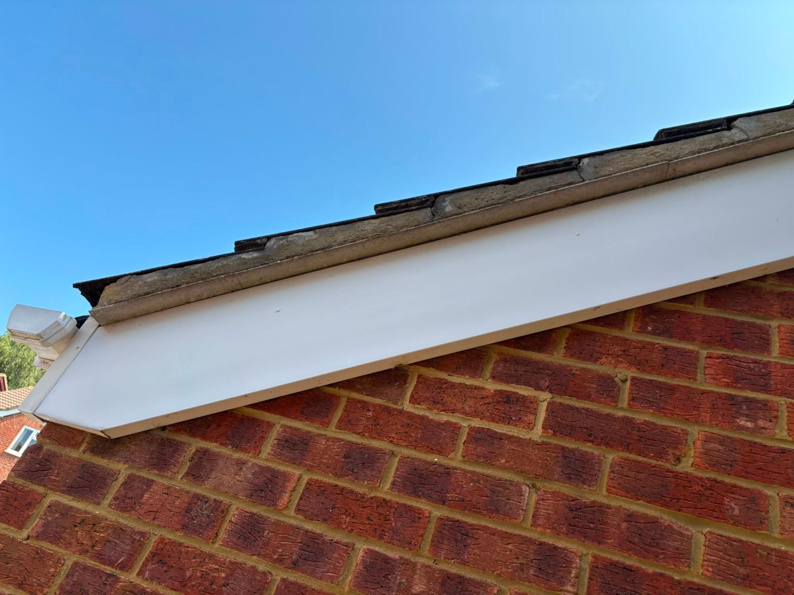 New white uPVC fascia and bargeboard along a brick gable