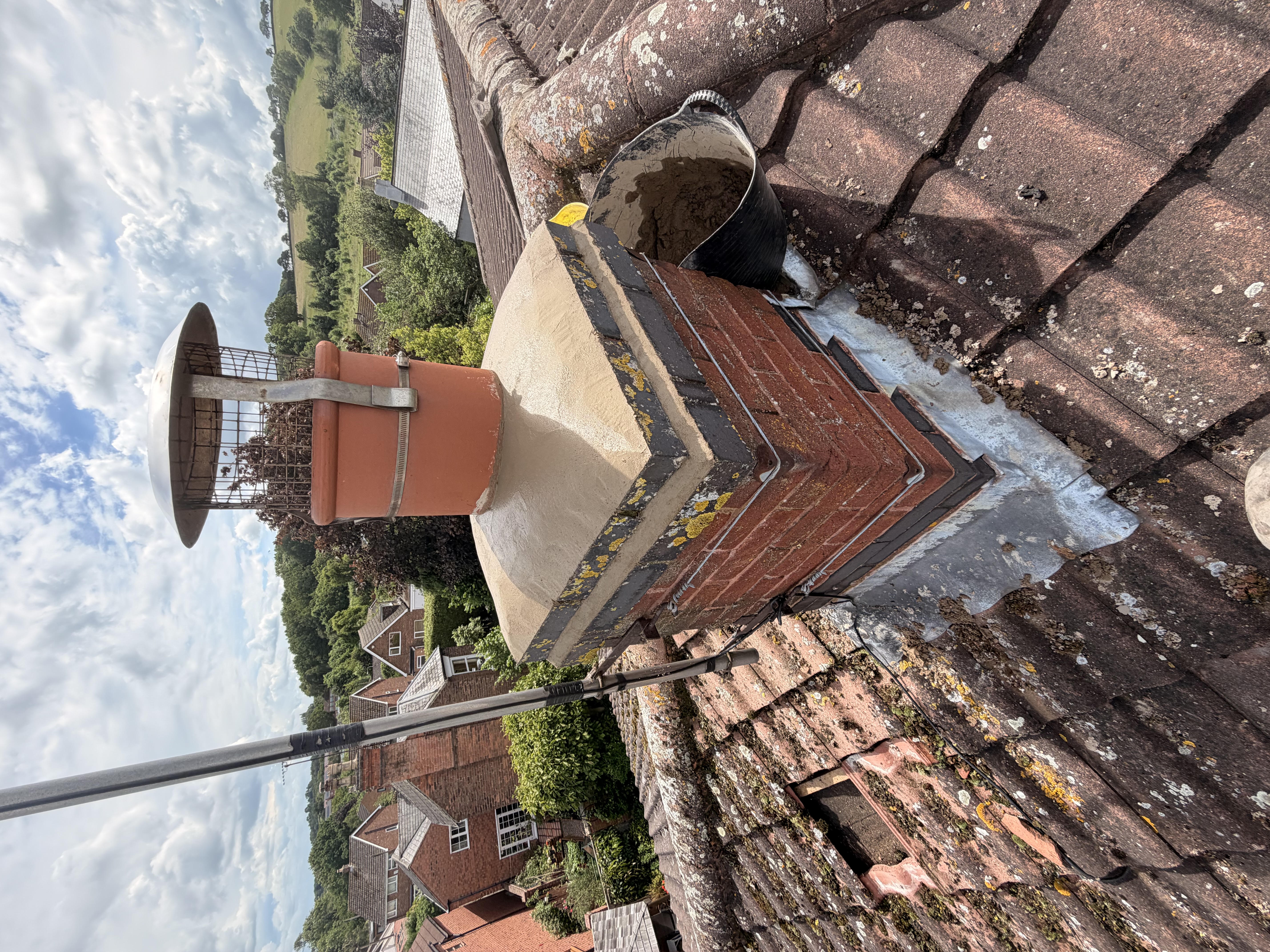 Section of roof with new flashing and pointing worked in around brickwork