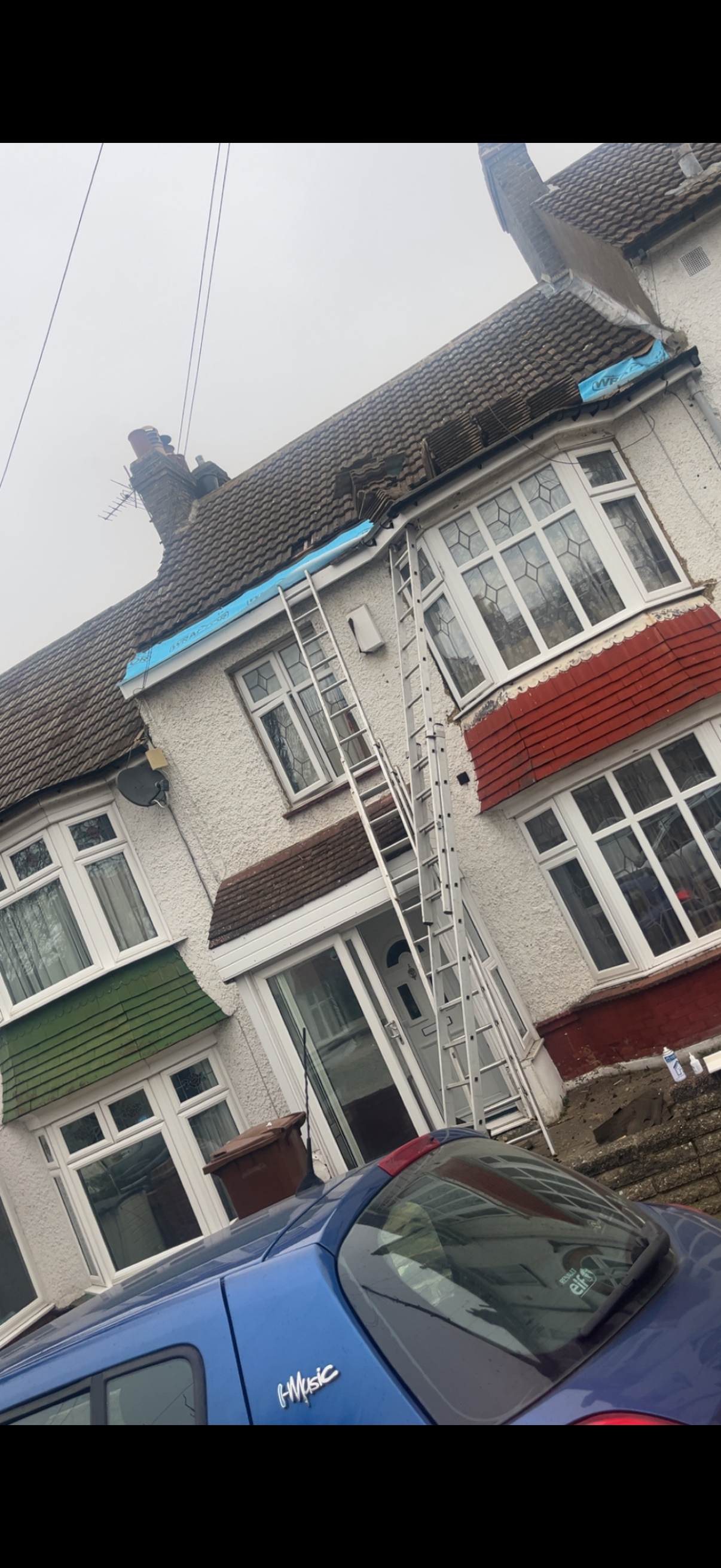 Freshly laid roof tiles running in neat courses up to the ridge