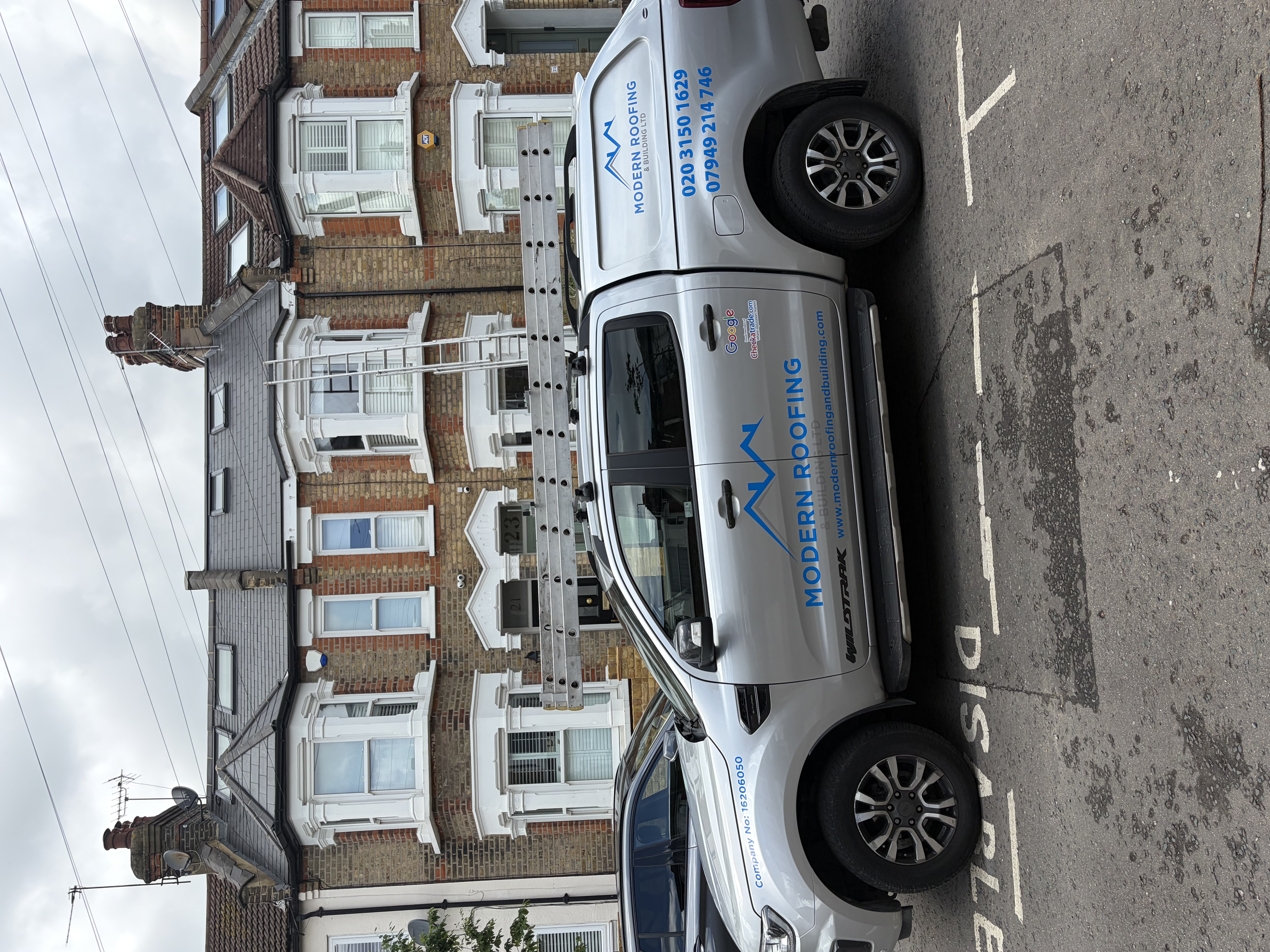 Completed grey tiled roof with a rooflight set into the slope