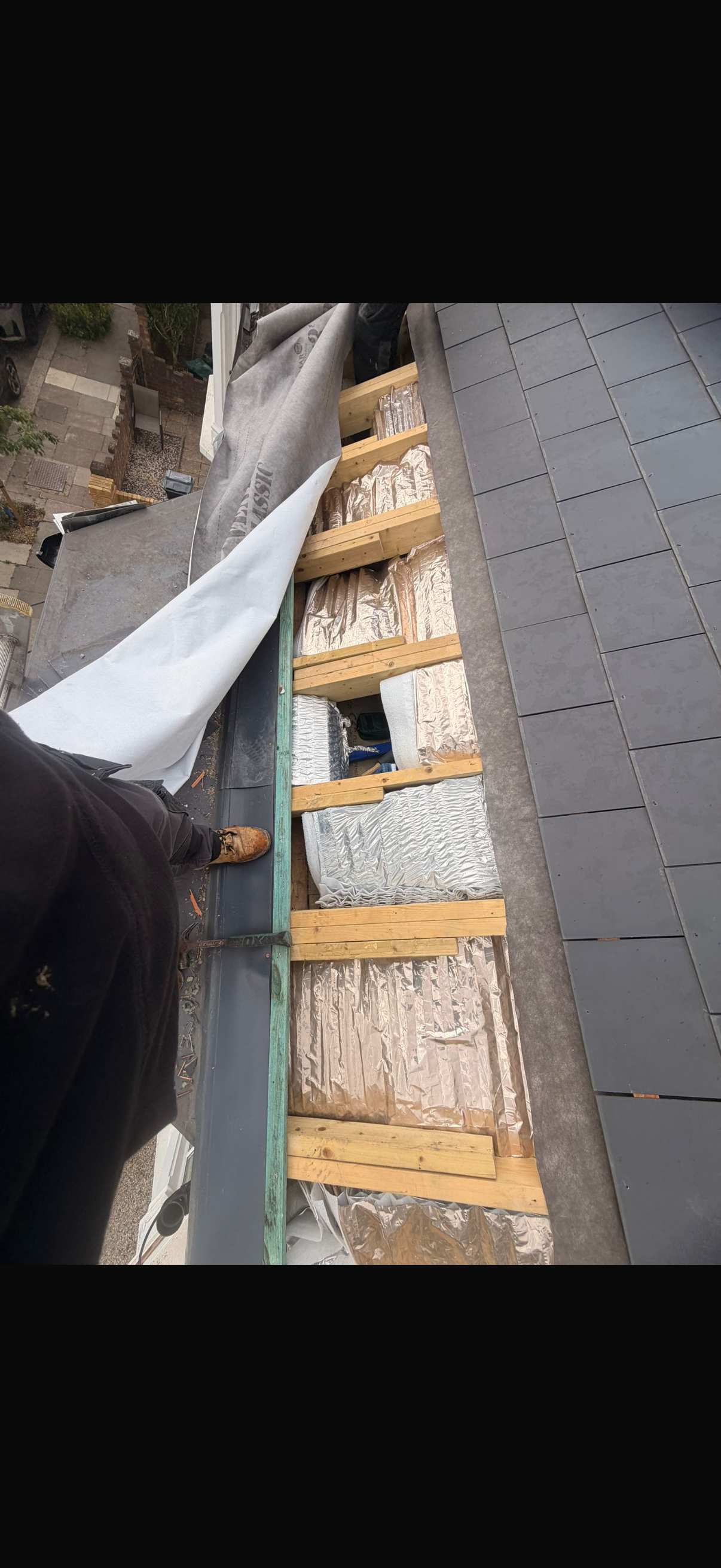 Breathable membrane and blue treated battens fixed across a roof slope