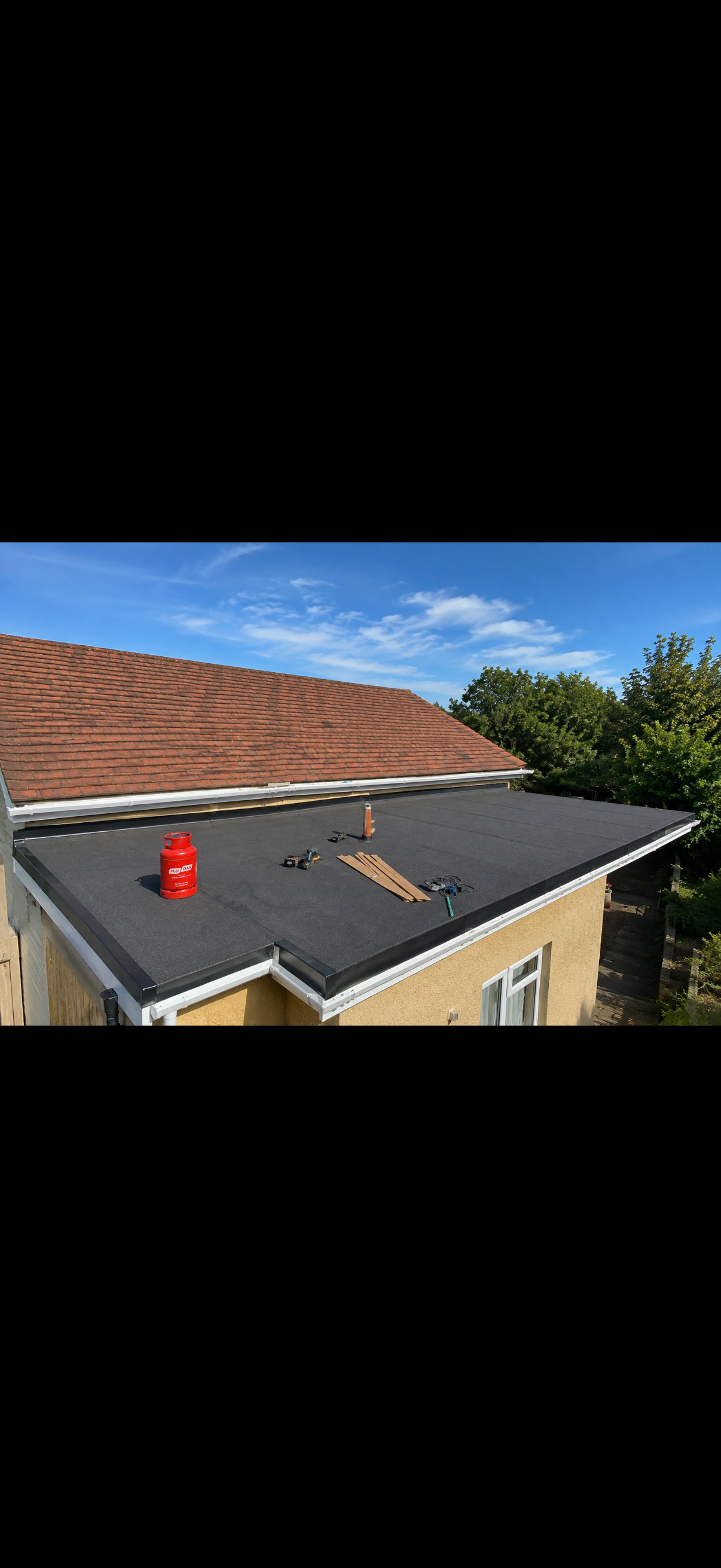 New roof covering seen from above with the garden and street beyond