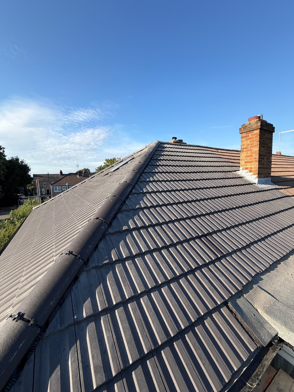 Grey tiled roof photographed from the scaffold boards at eaves level