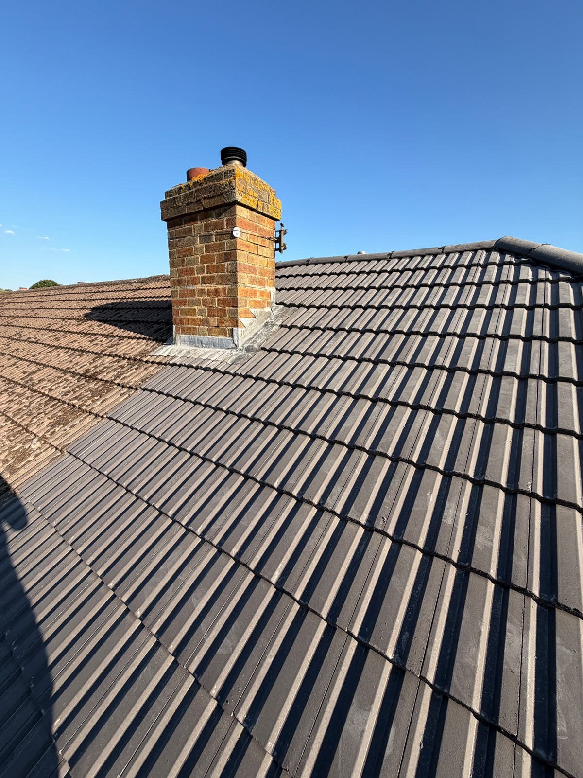 New guttering and fascia board fitted along the edge of a tiled roof