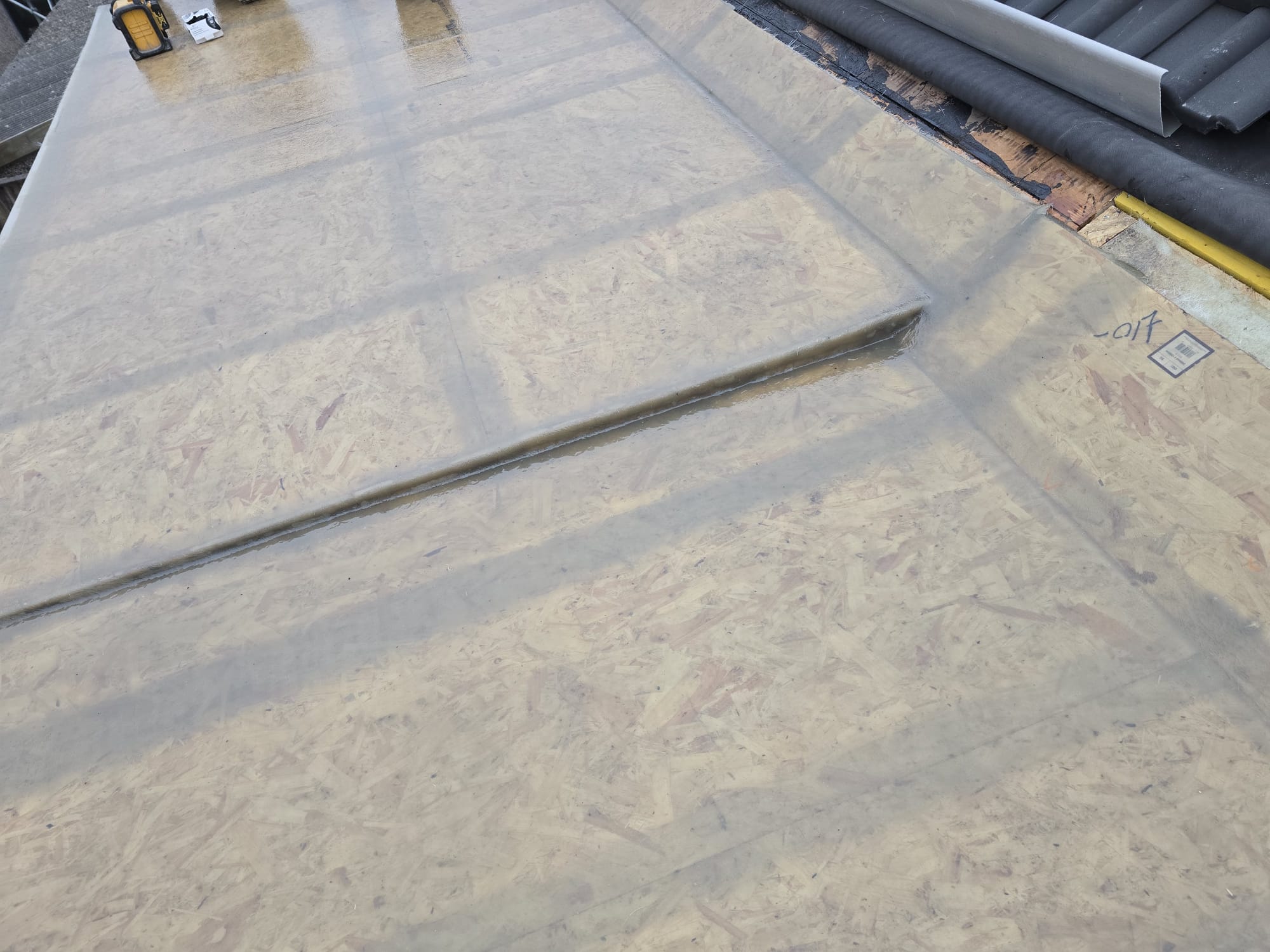 Tiled roof and chimney seen from the scaffold