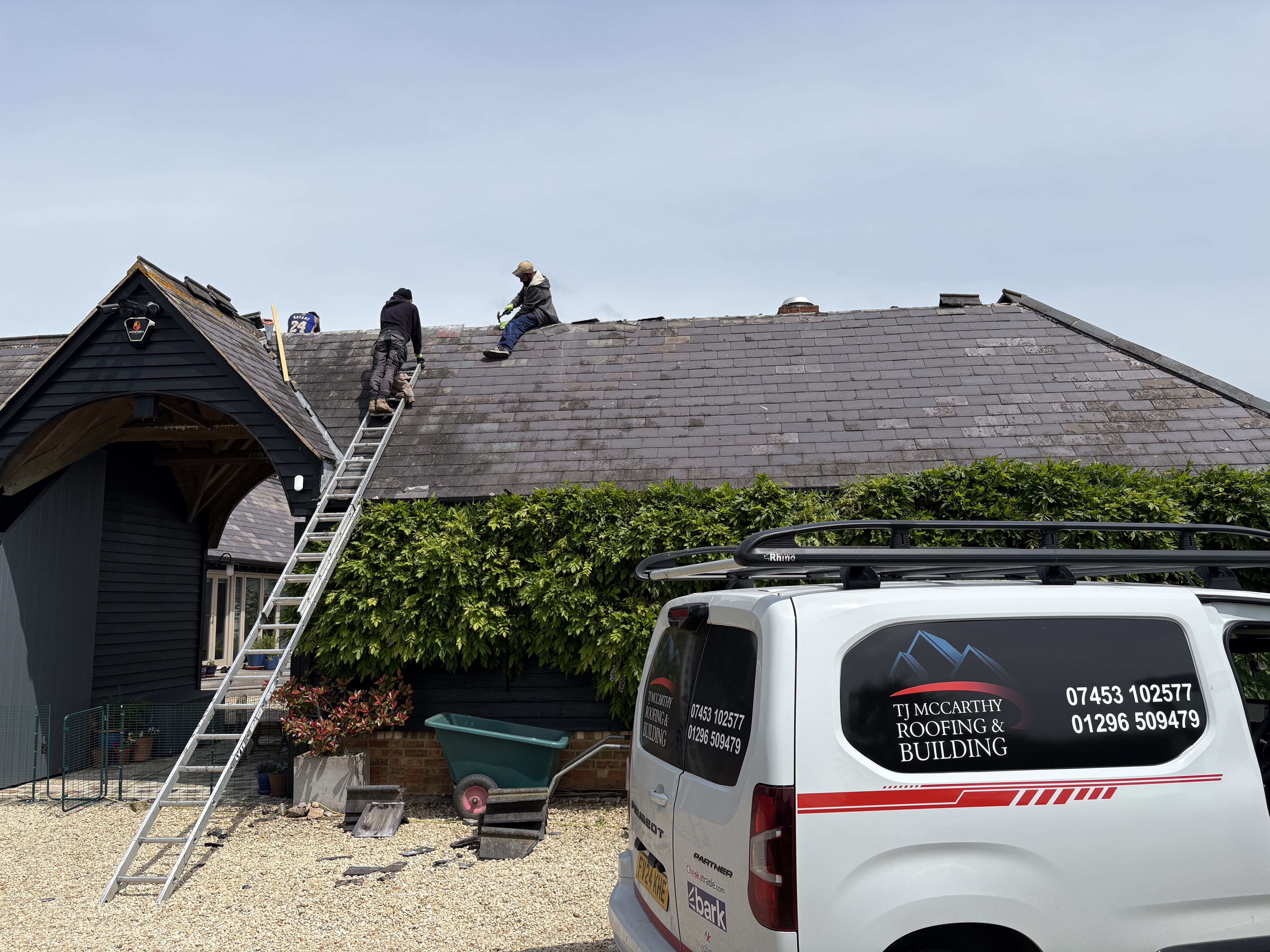 A finished roof and rainwater goods on a house, photographed from the scaffold