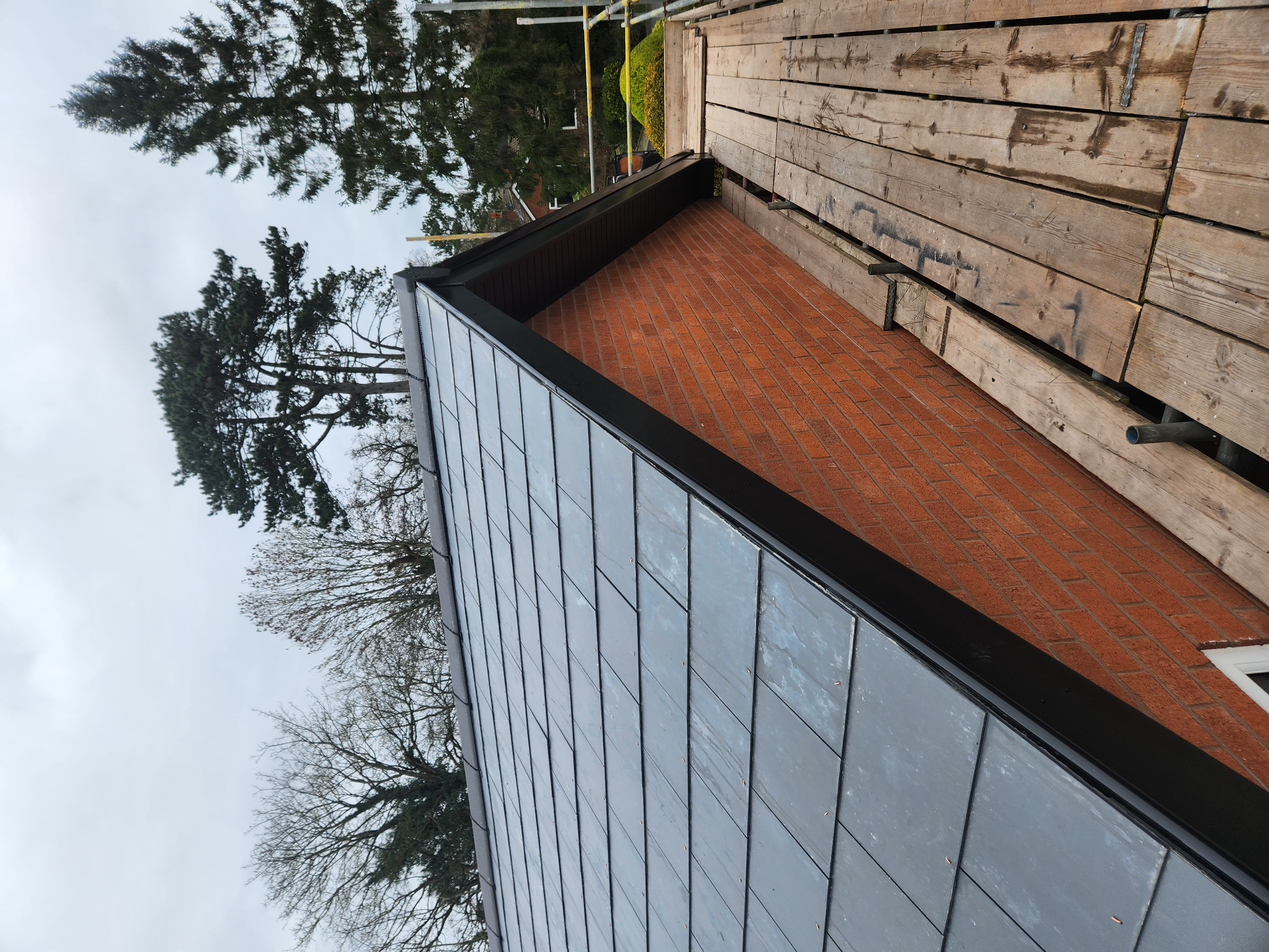 Roof hip finished in dark slates with new dry ridge along the top