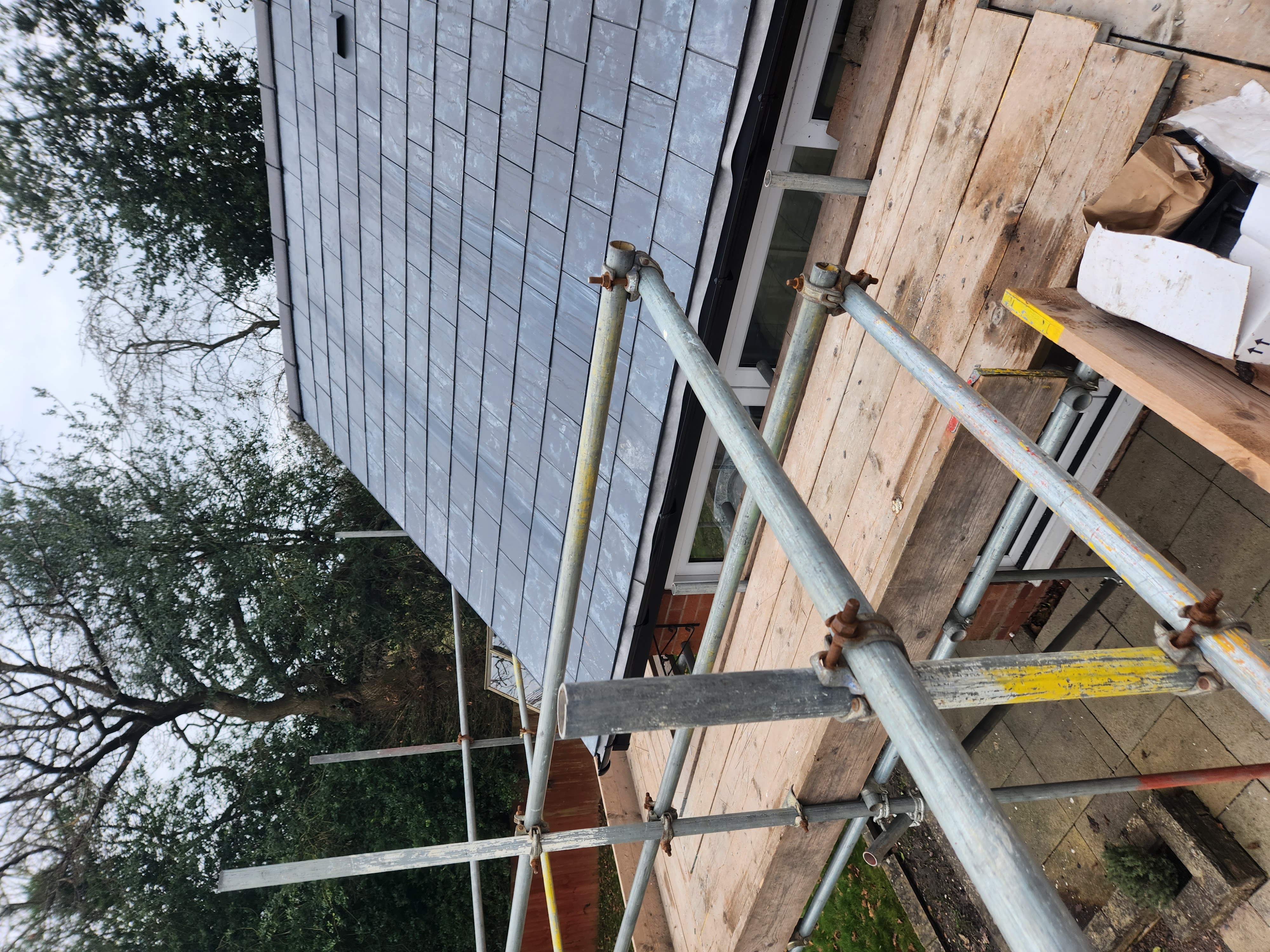Close view of laid slates showing even courses and copper nails