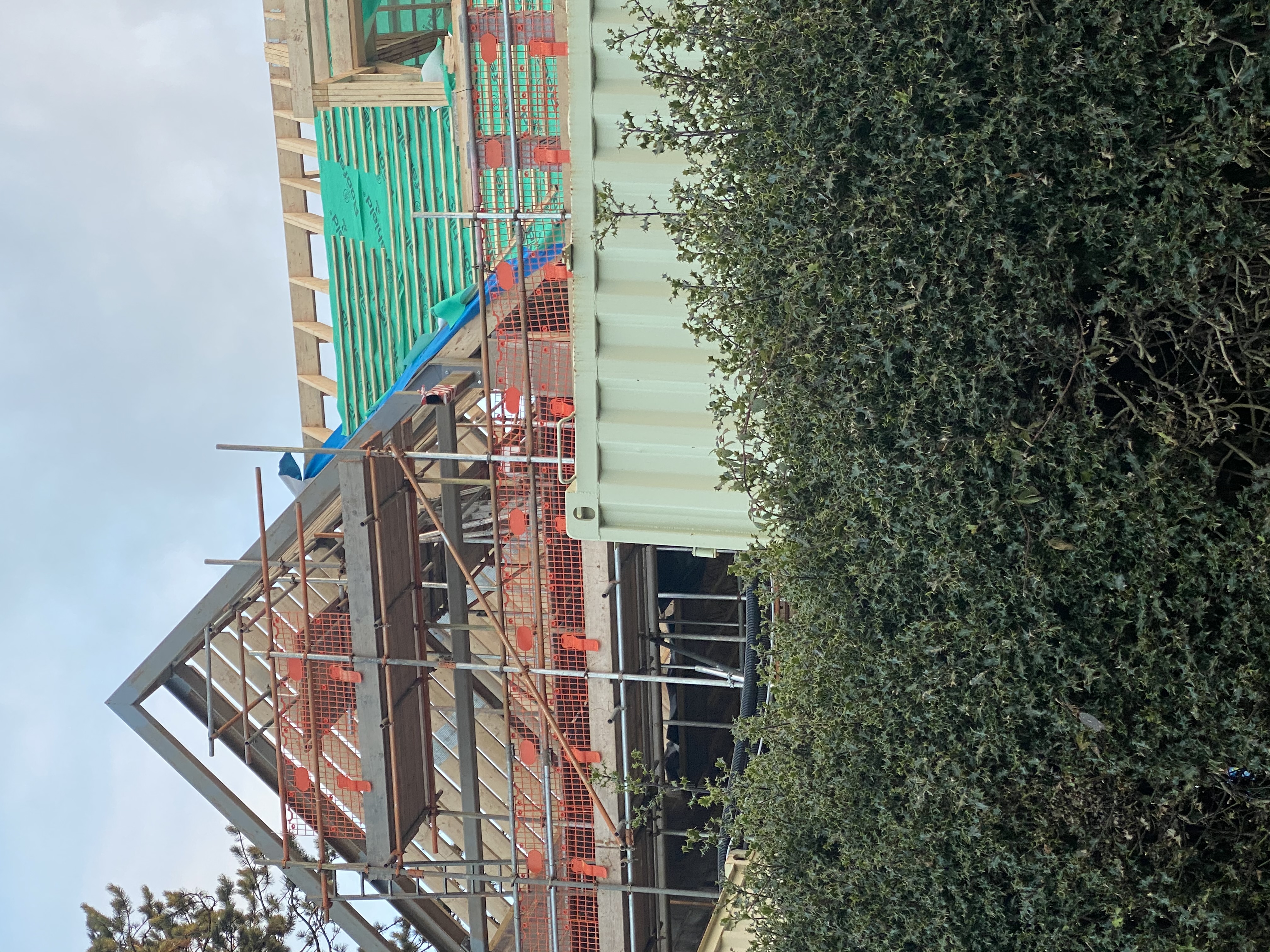 Dark grey slates laid up to a newly leaded chimney