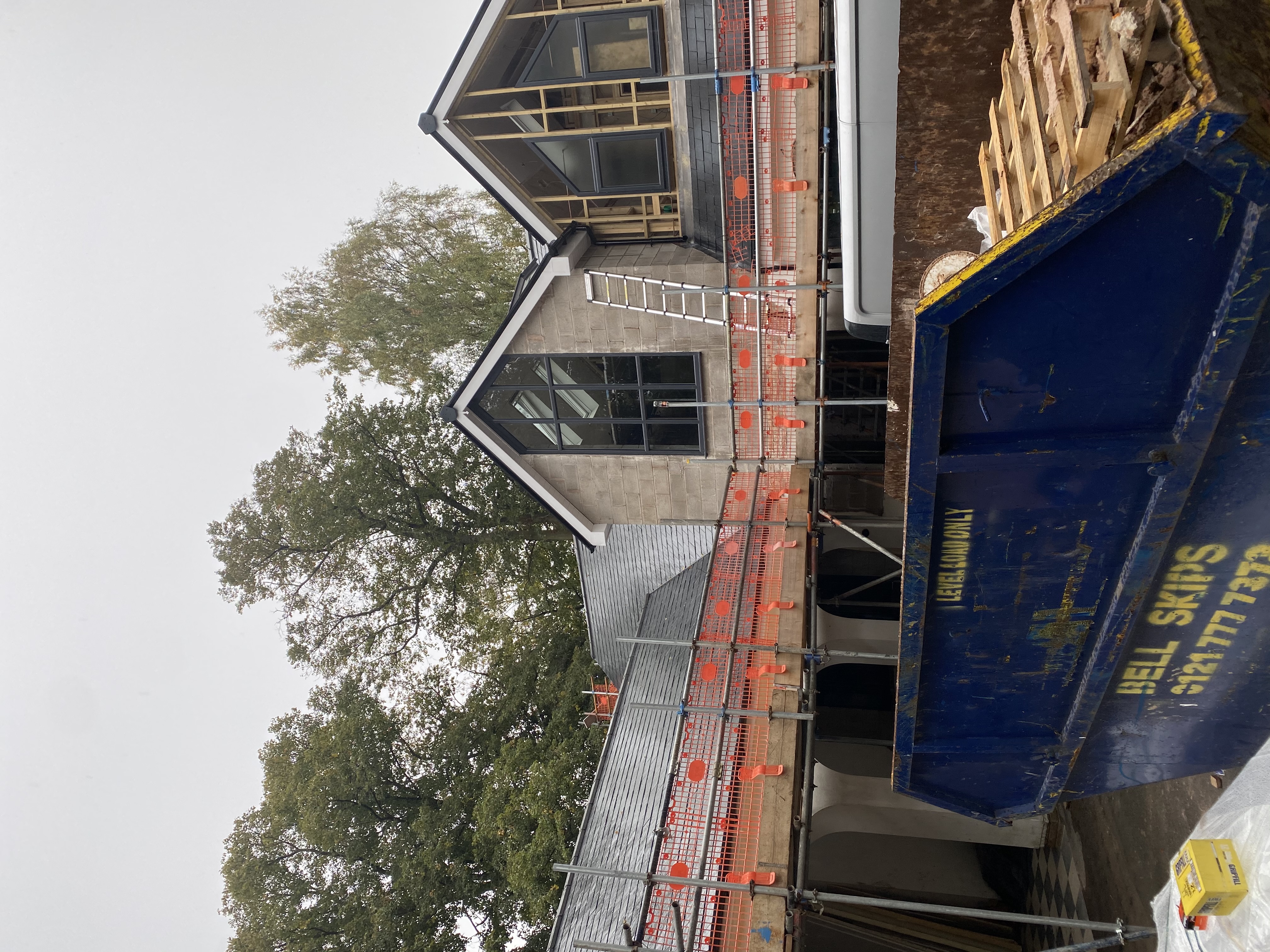 Slates laid across a wide roof slope with new ridge capping