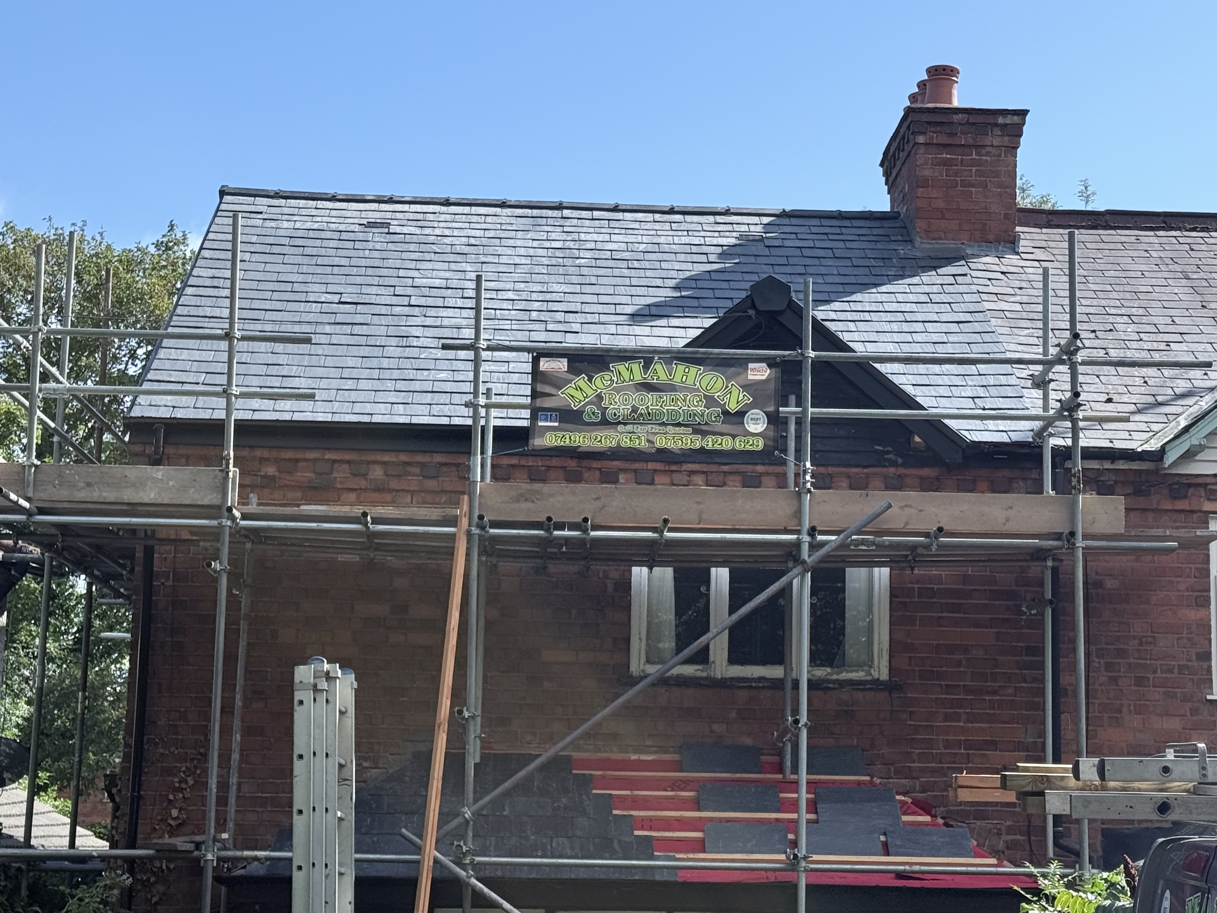 Tiled roof with new ridge and neat cut tiles at the valley