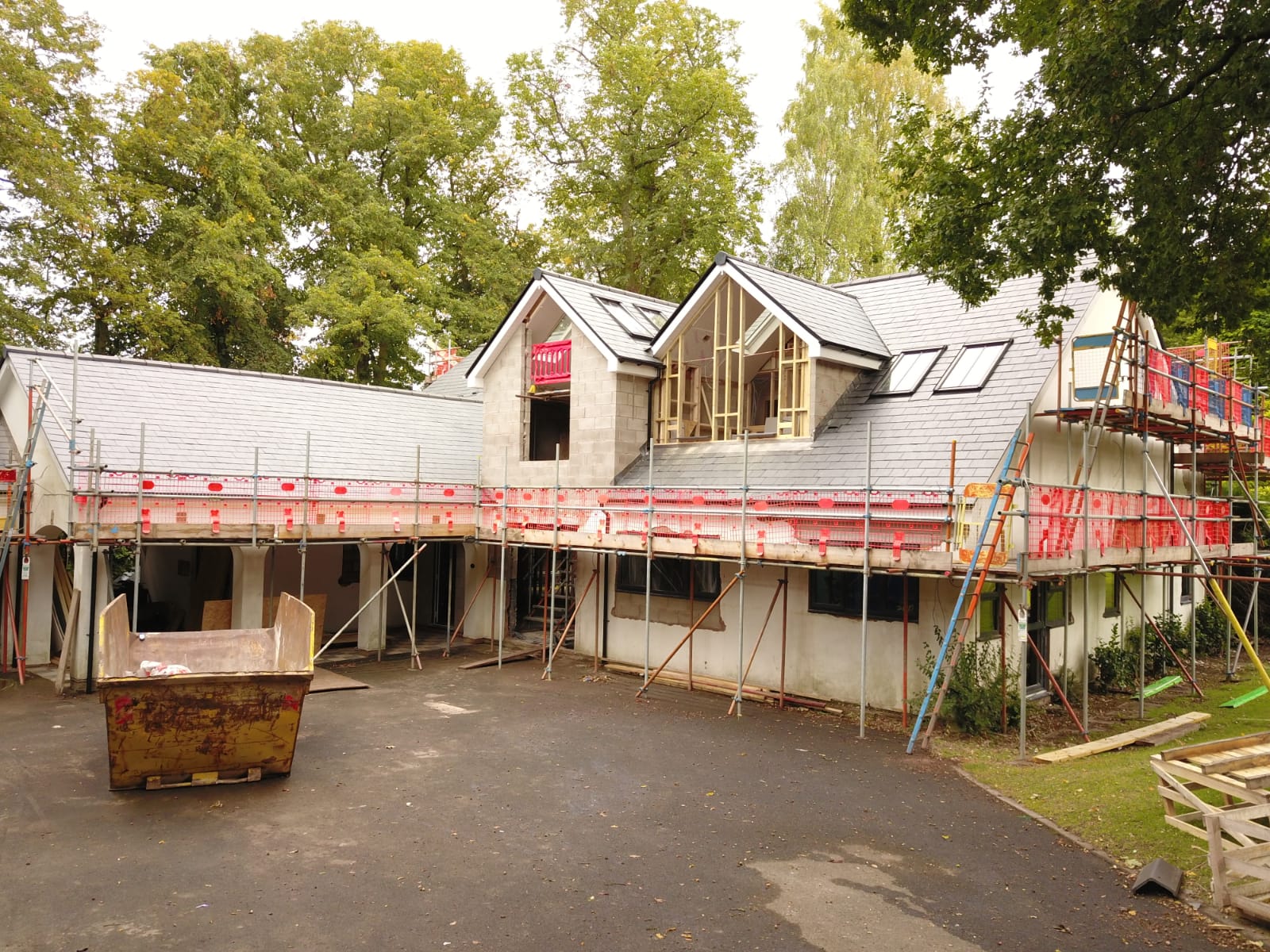 Large domestic roof finished in grey slate seen from above