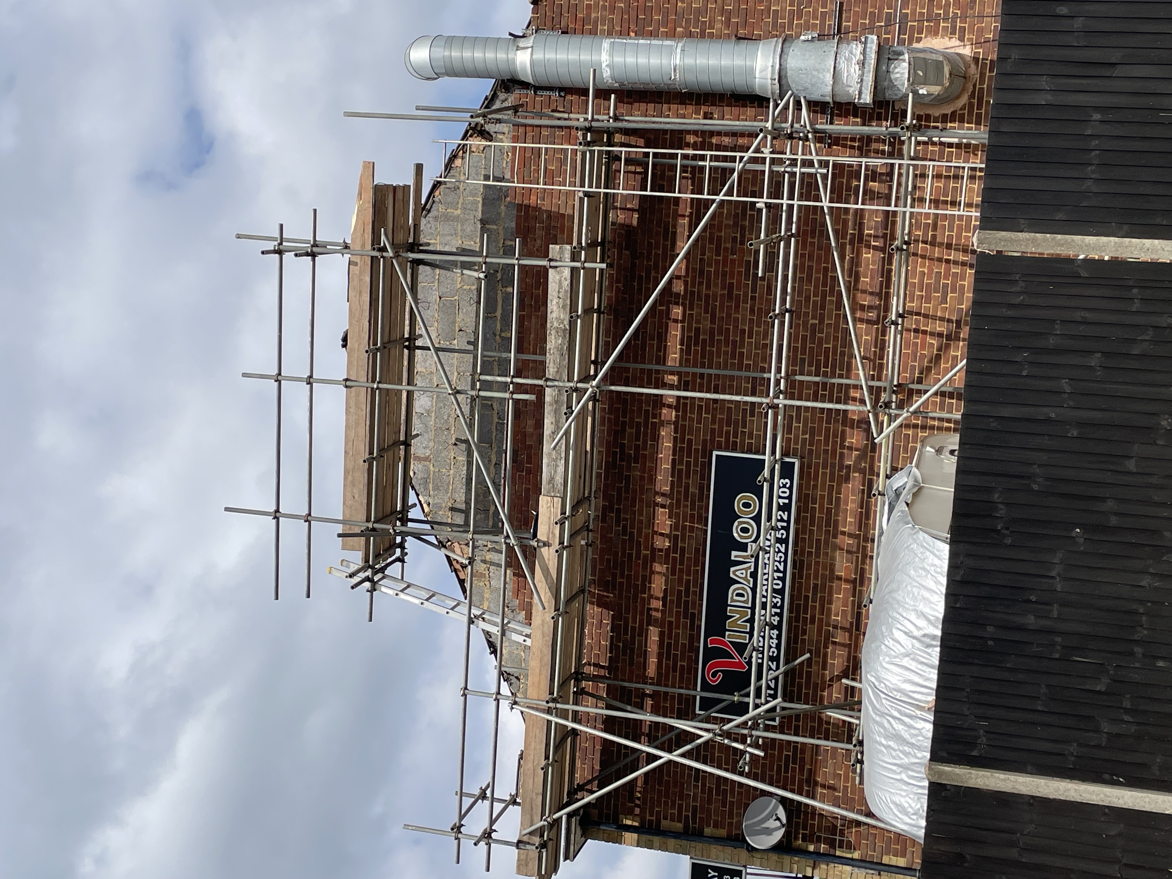 Pitched tiled roof photographed from scaffolding