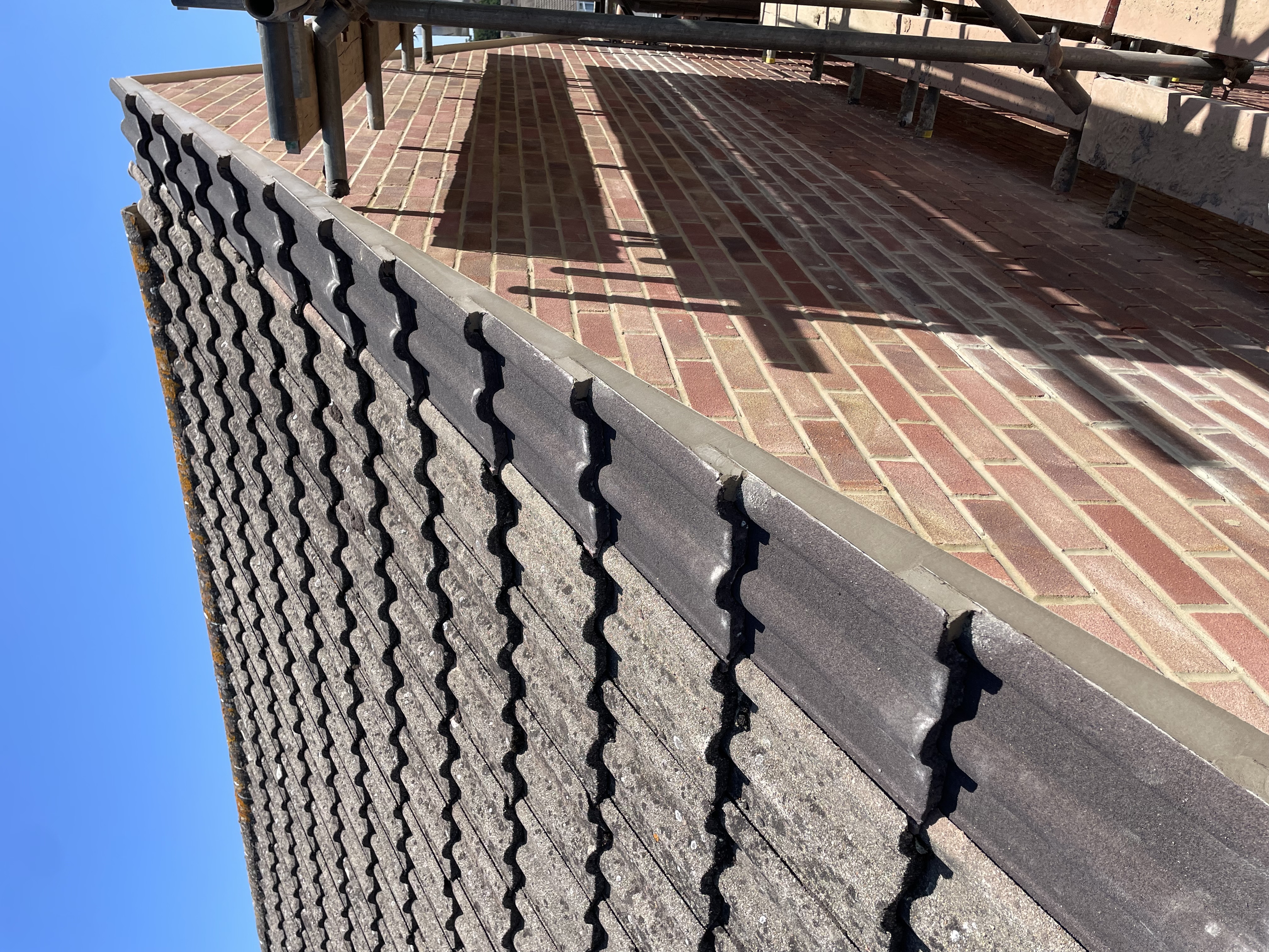 Roof slope with fresh tiling along the ridge