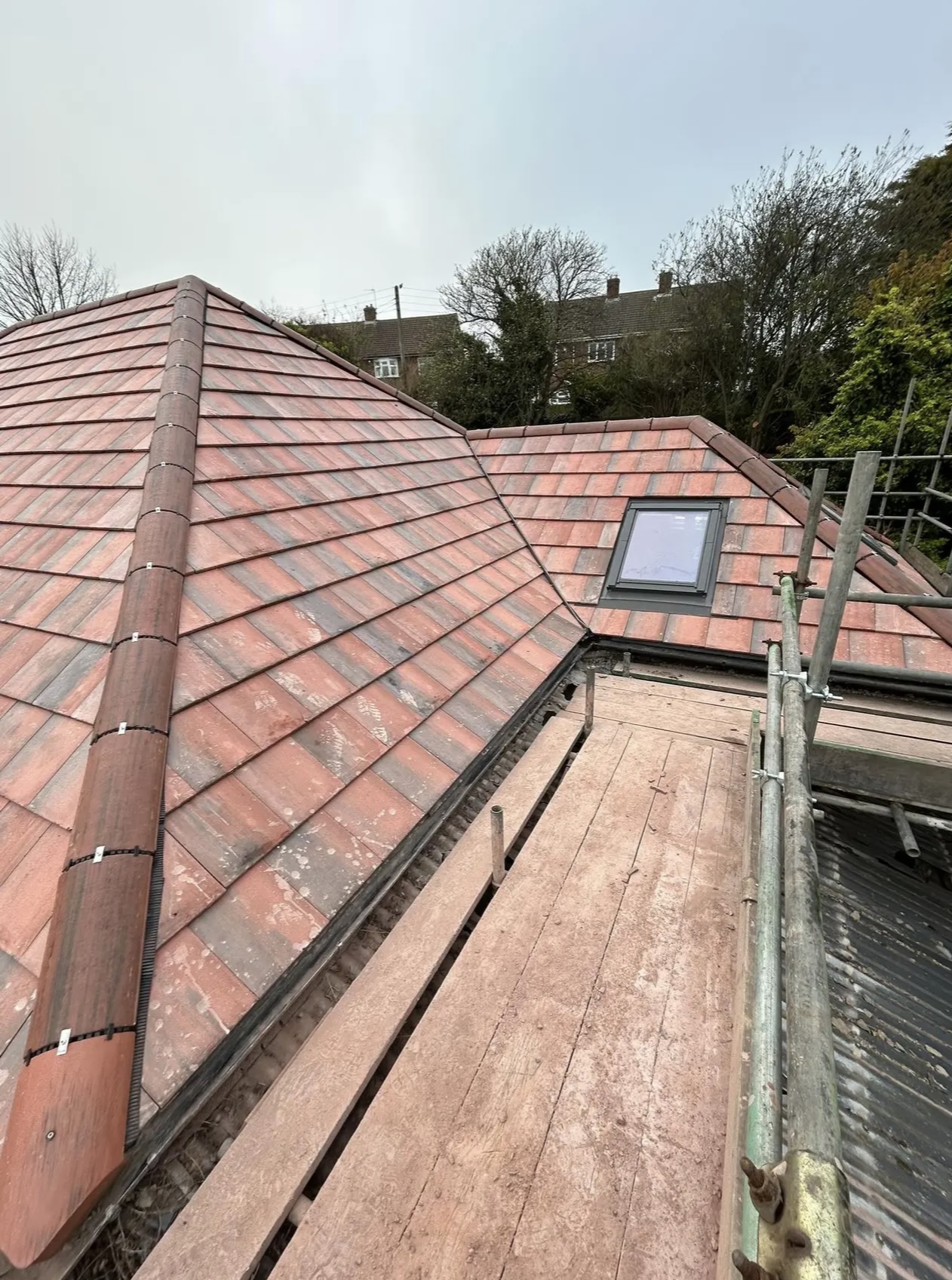 Red tiled roof with two rooflights fitted neatly into the slope
