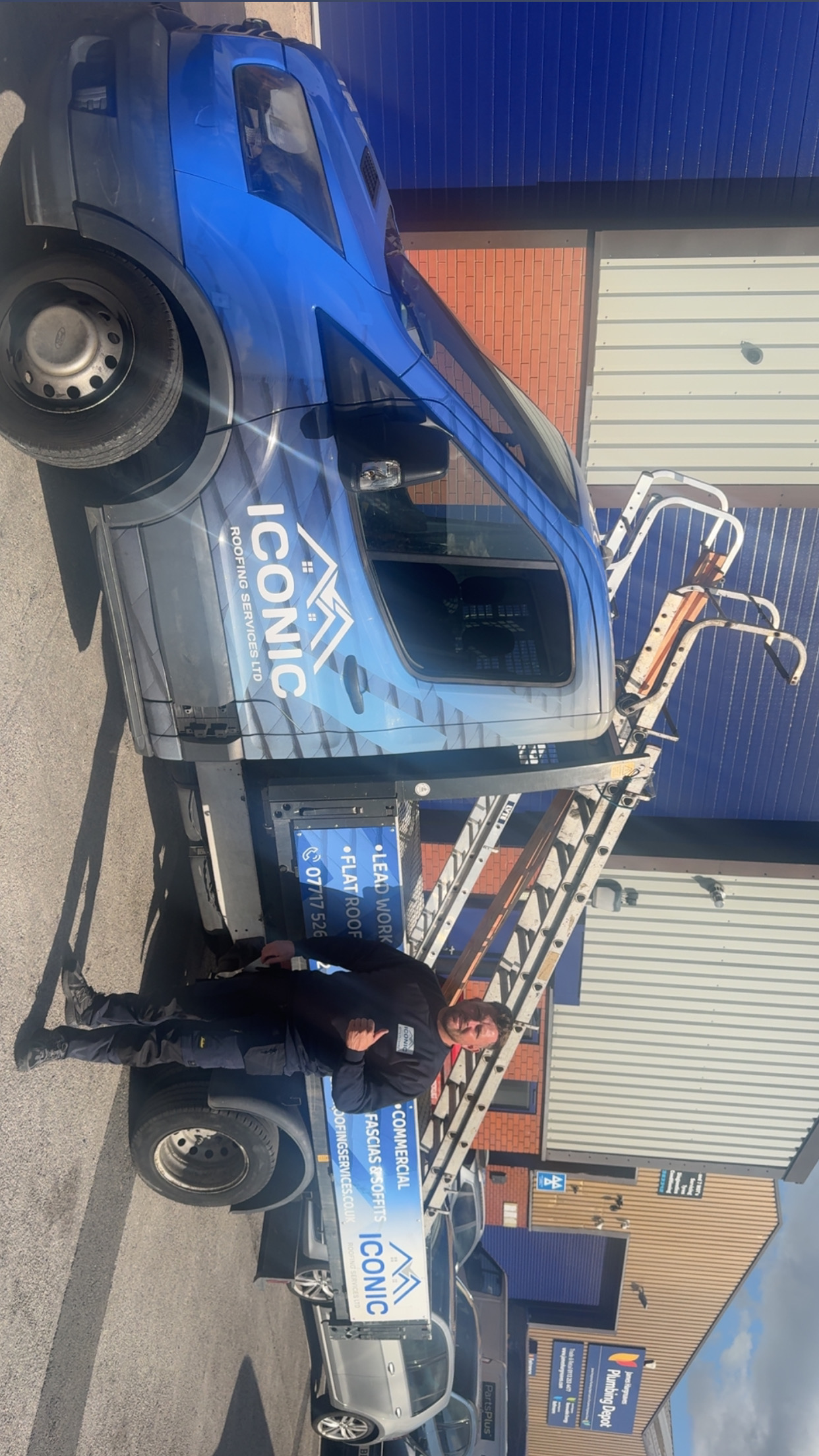 Lee beside the Iconic Roofing Services LTD van with ladders loaded, ready for a survey in Leeds