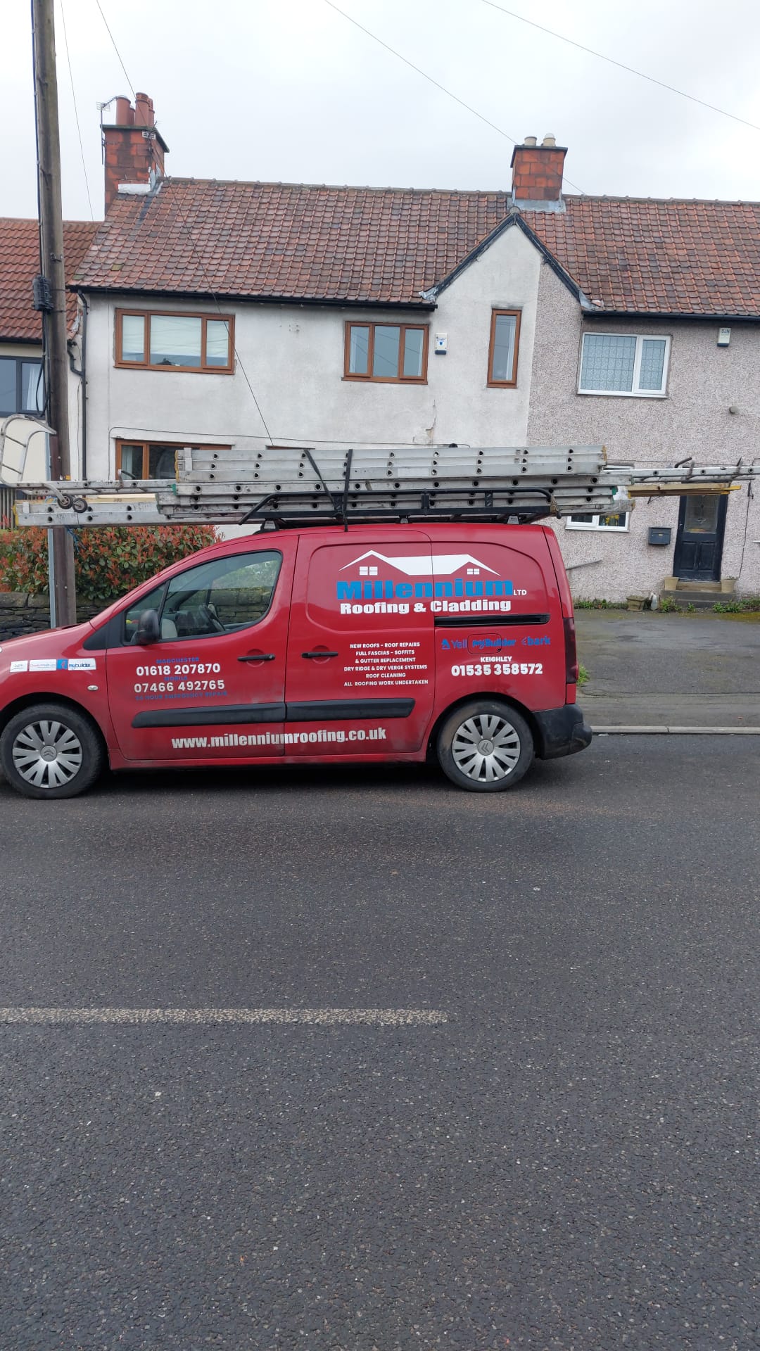Millenium Roofing & Cladding work van parked in a residential street