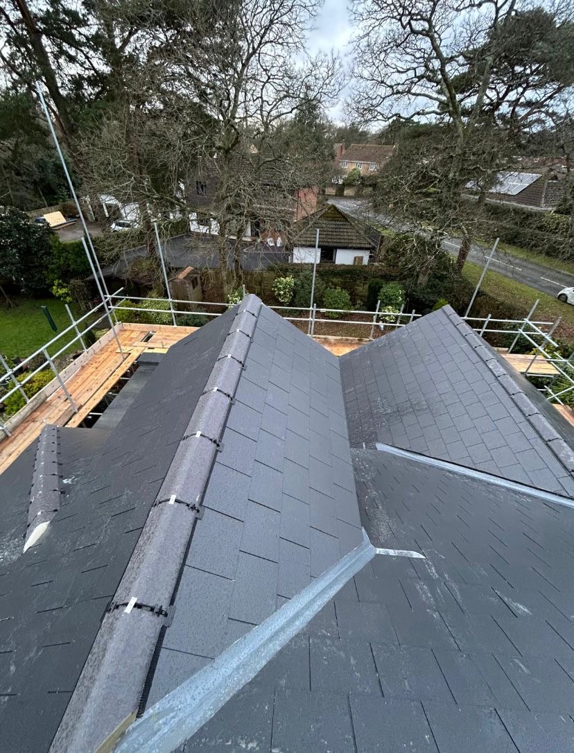 New grey tiled roof seen from scaffolding
