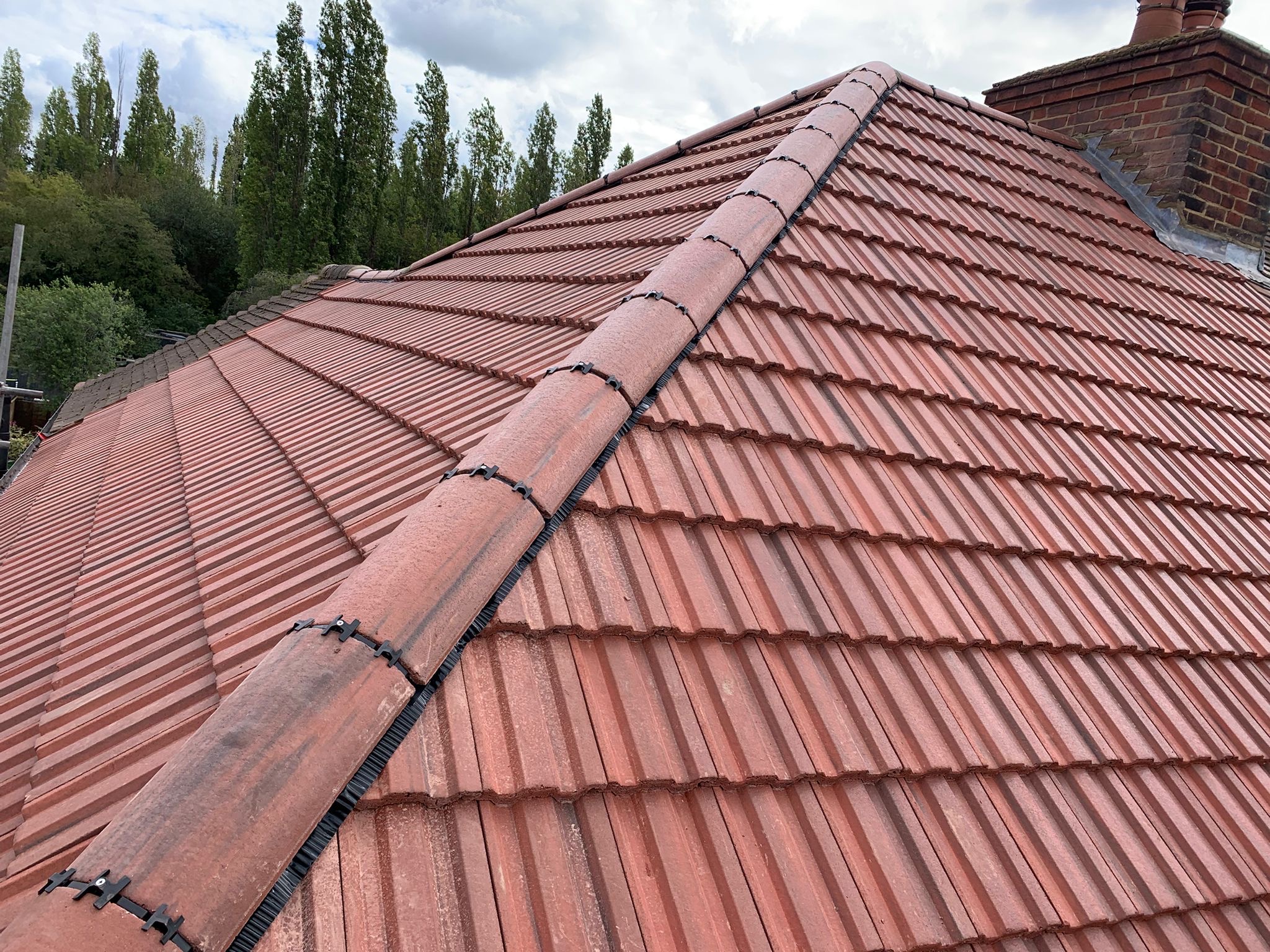 Red tiled roof with a neatly finished ridge line