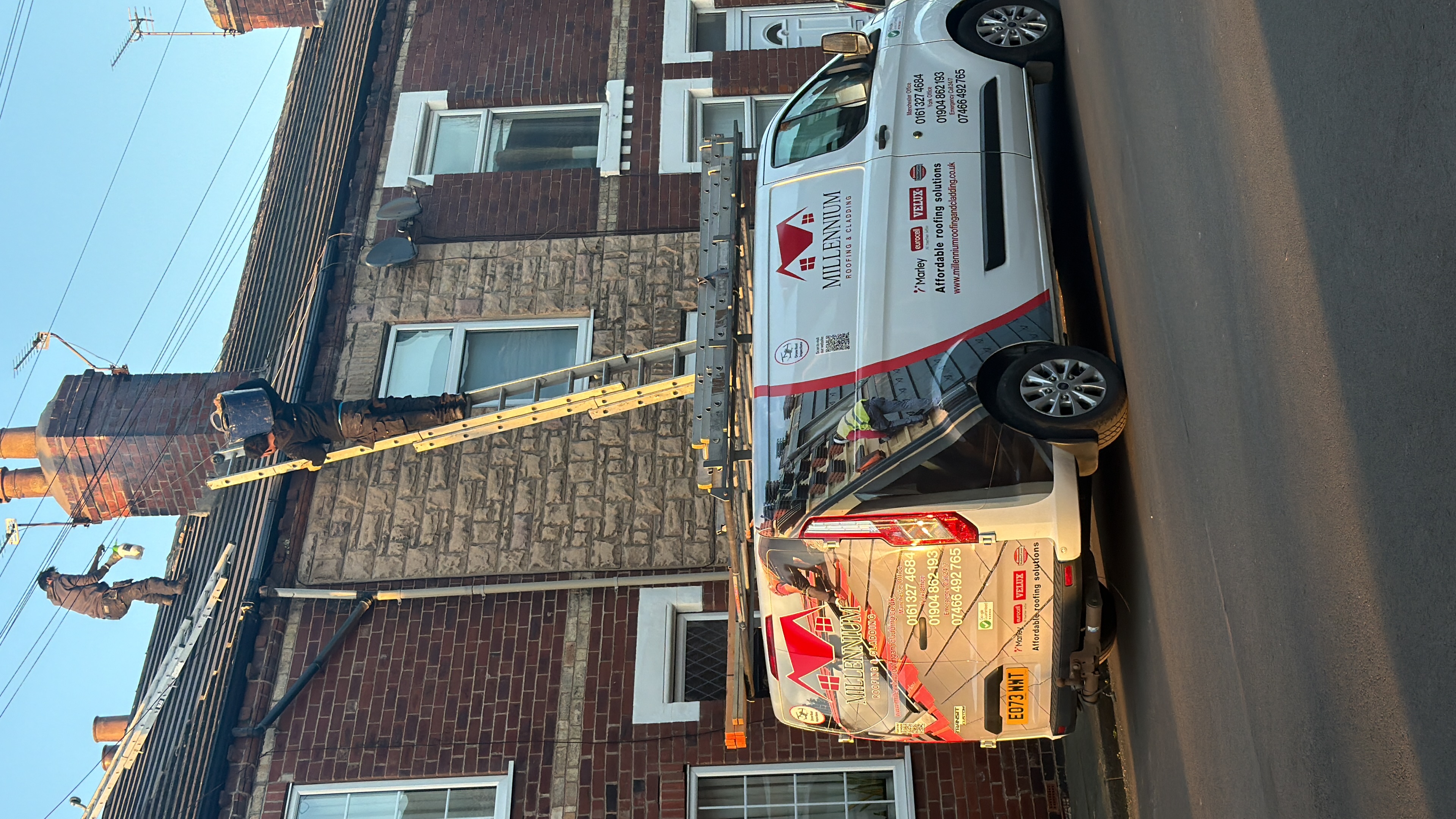 Roofing work underway beside a Millenium Roofing & Cladding van