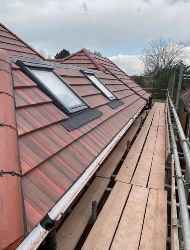Red tiled roof with three fitted roof windows