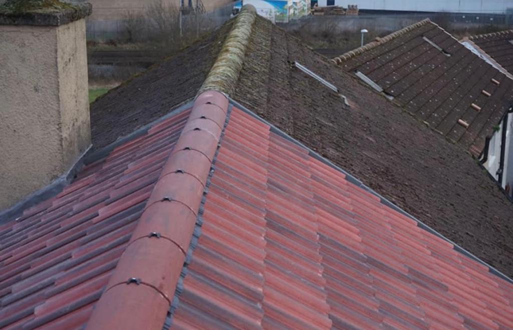 Red tiled roof ridge viewed along its length
