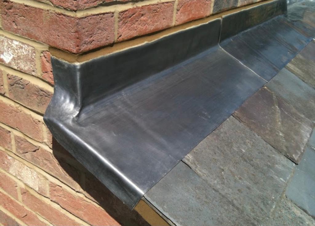 Close view of smooth lead flashing fitted below brickwork