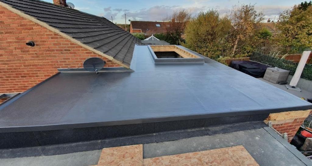 Finished dark flat roof with a roof window