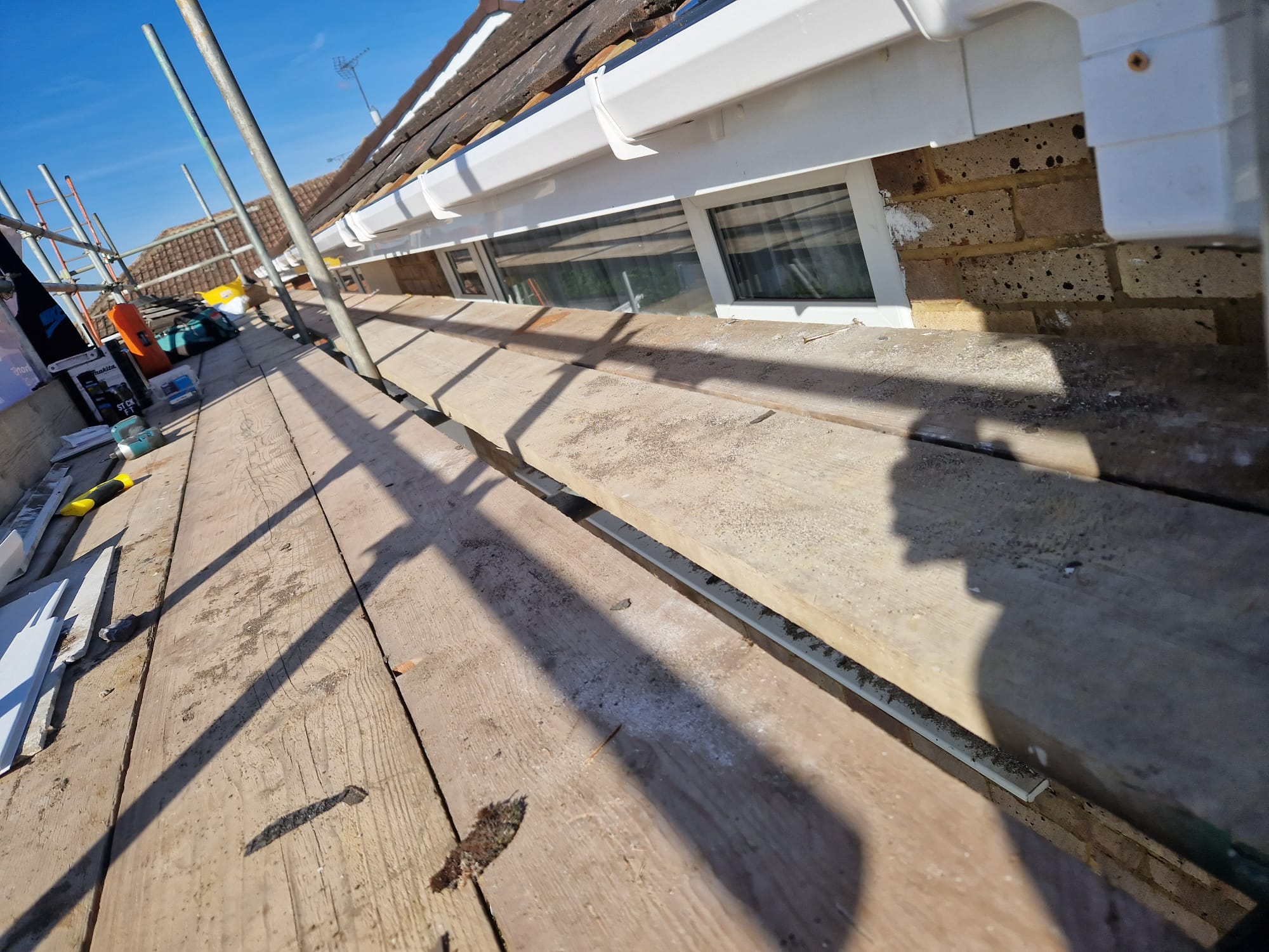 Timber roof deck exposed during roofing work