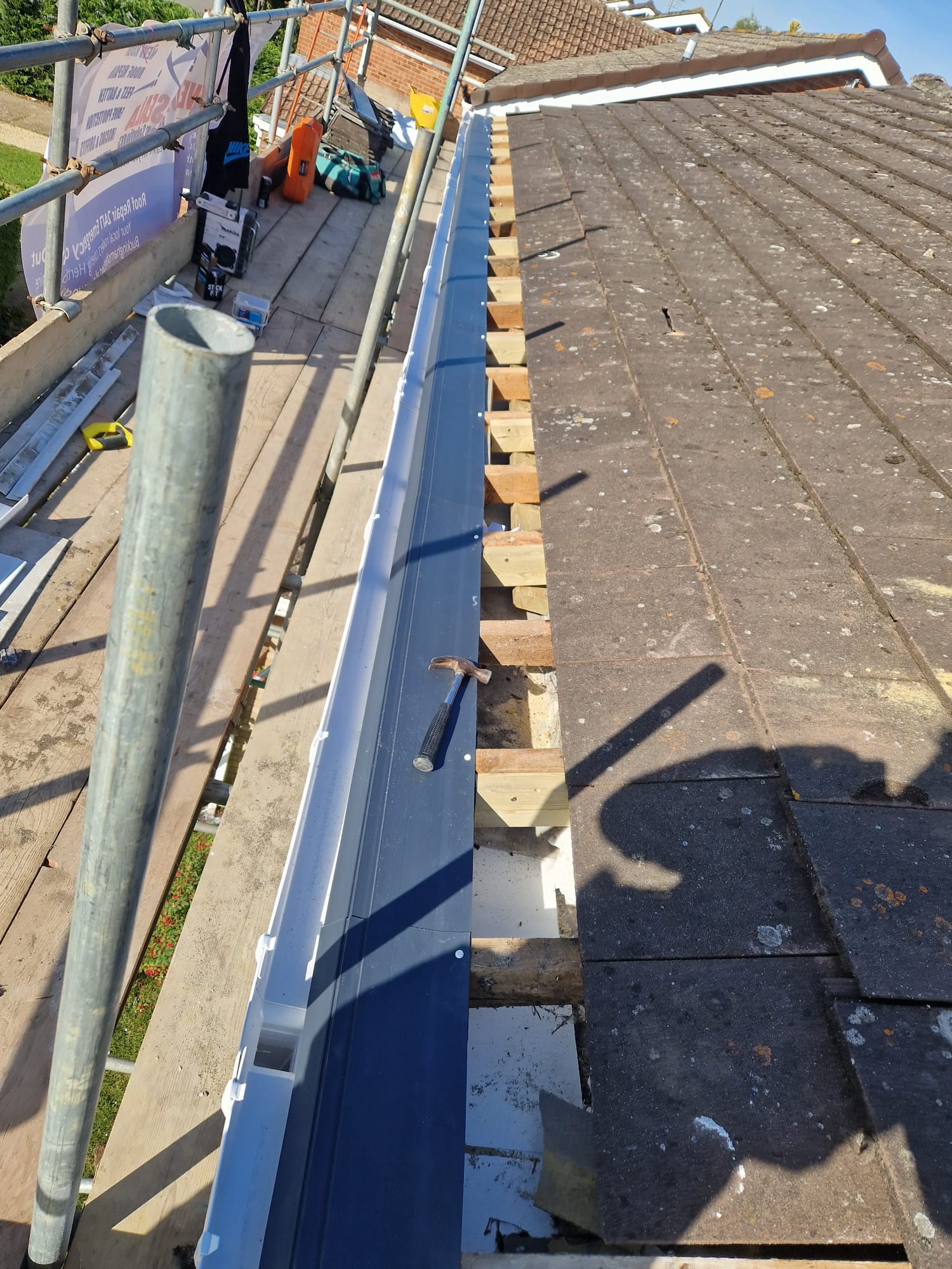 New blue guttering fitted along a roof edge