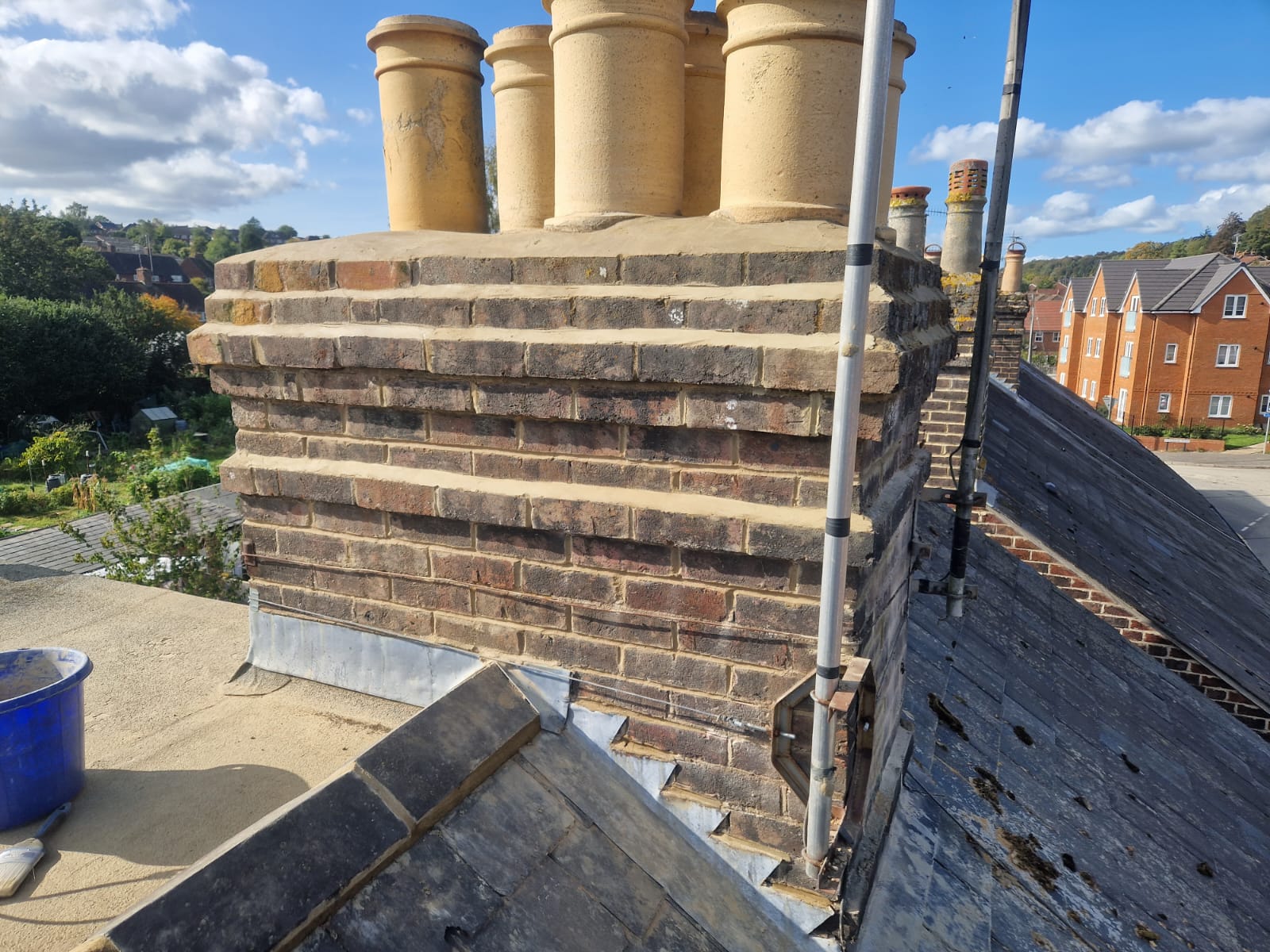 Close view of a brick chimney stack and chimney pots