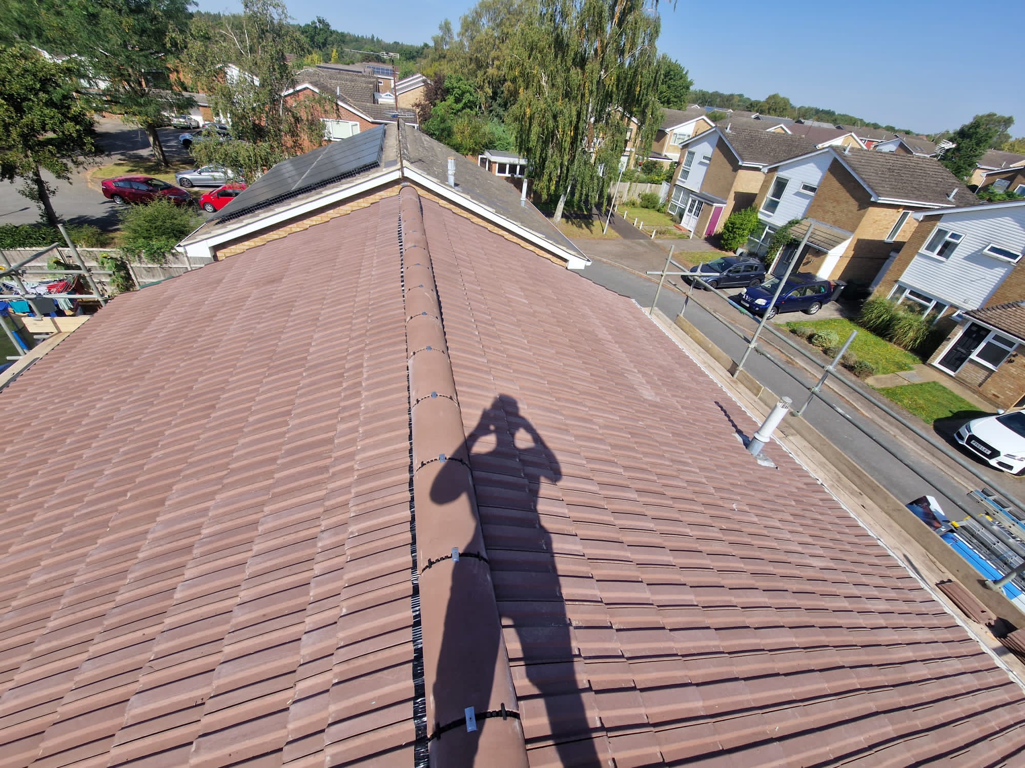 Completed red tiled roof viewed from the ridge