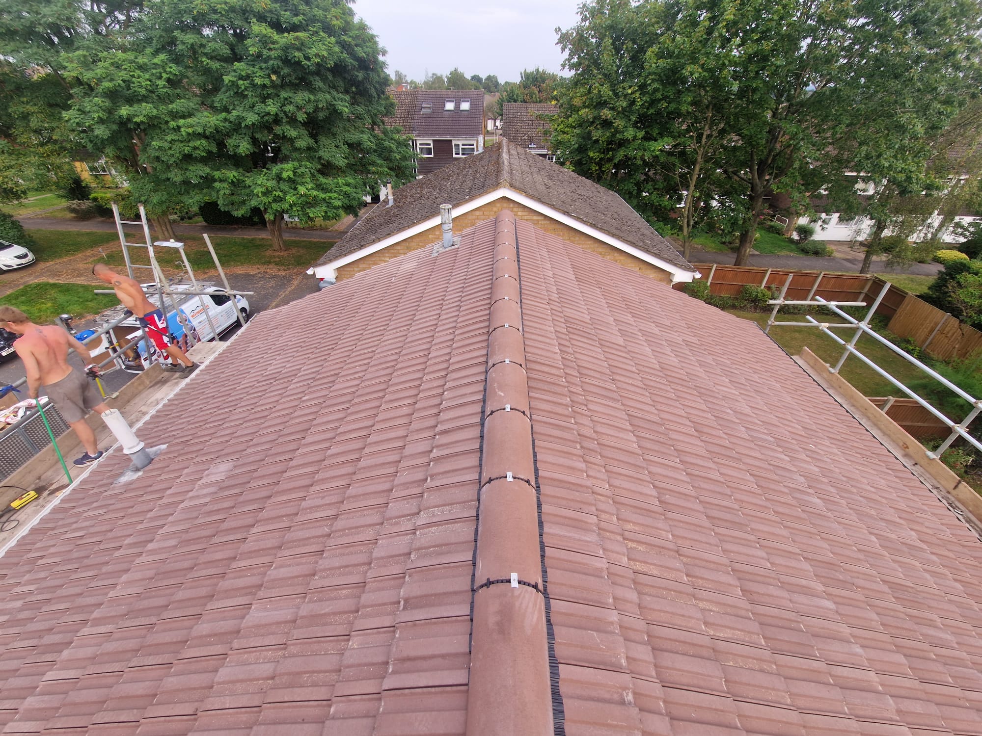 Completed red tiled hipped roof viewed from above