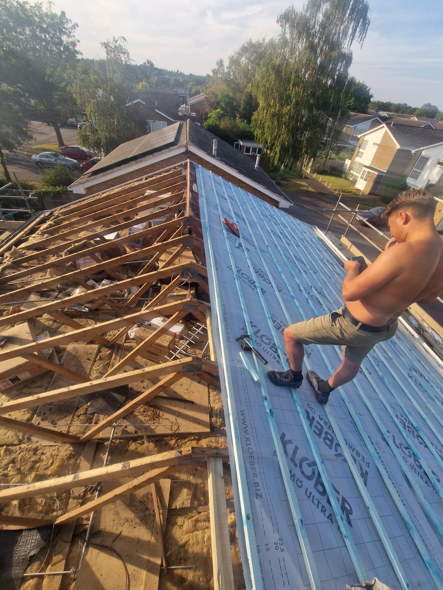 Roof tiles removed to reveal membrane and timber battens