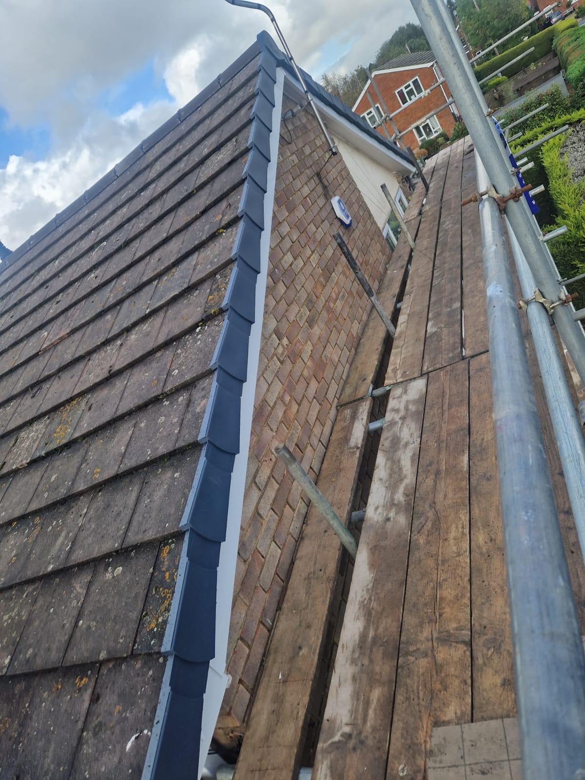 New dark verge tiles fitted along the side of a roof