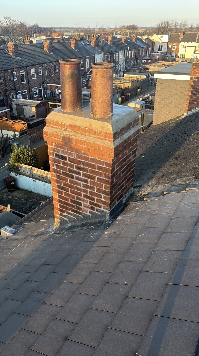 Repaired brick chimney with lead flashing at the base