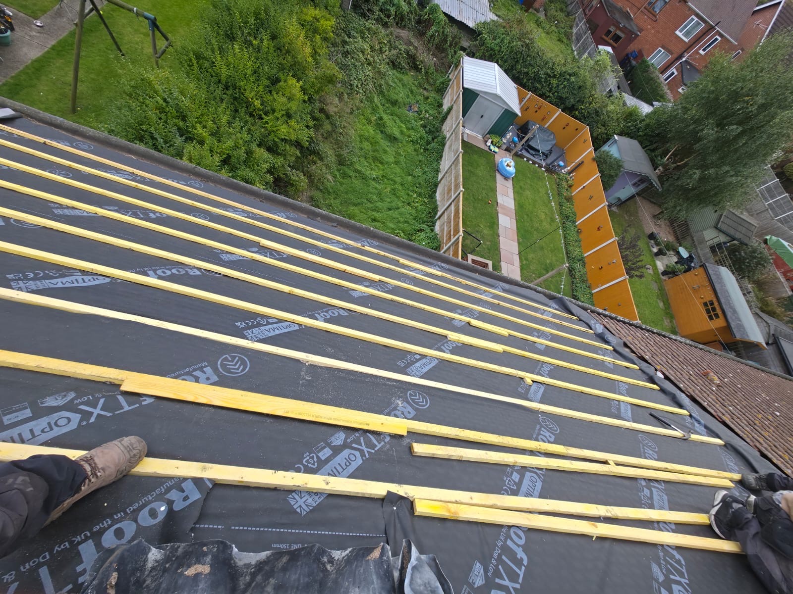 Roof slope prepared with membrane and battens, overlooking long back gardens