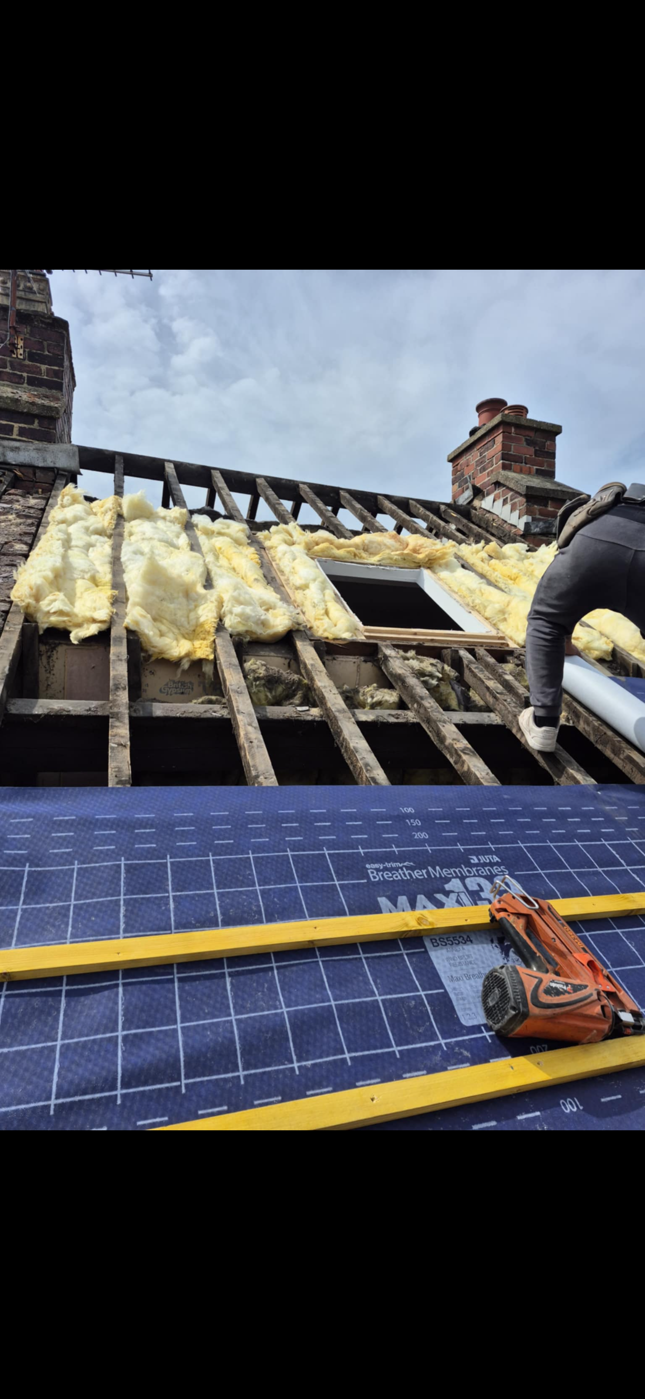Close view of concrete roof tiles with the ridge tiles freshly bedded