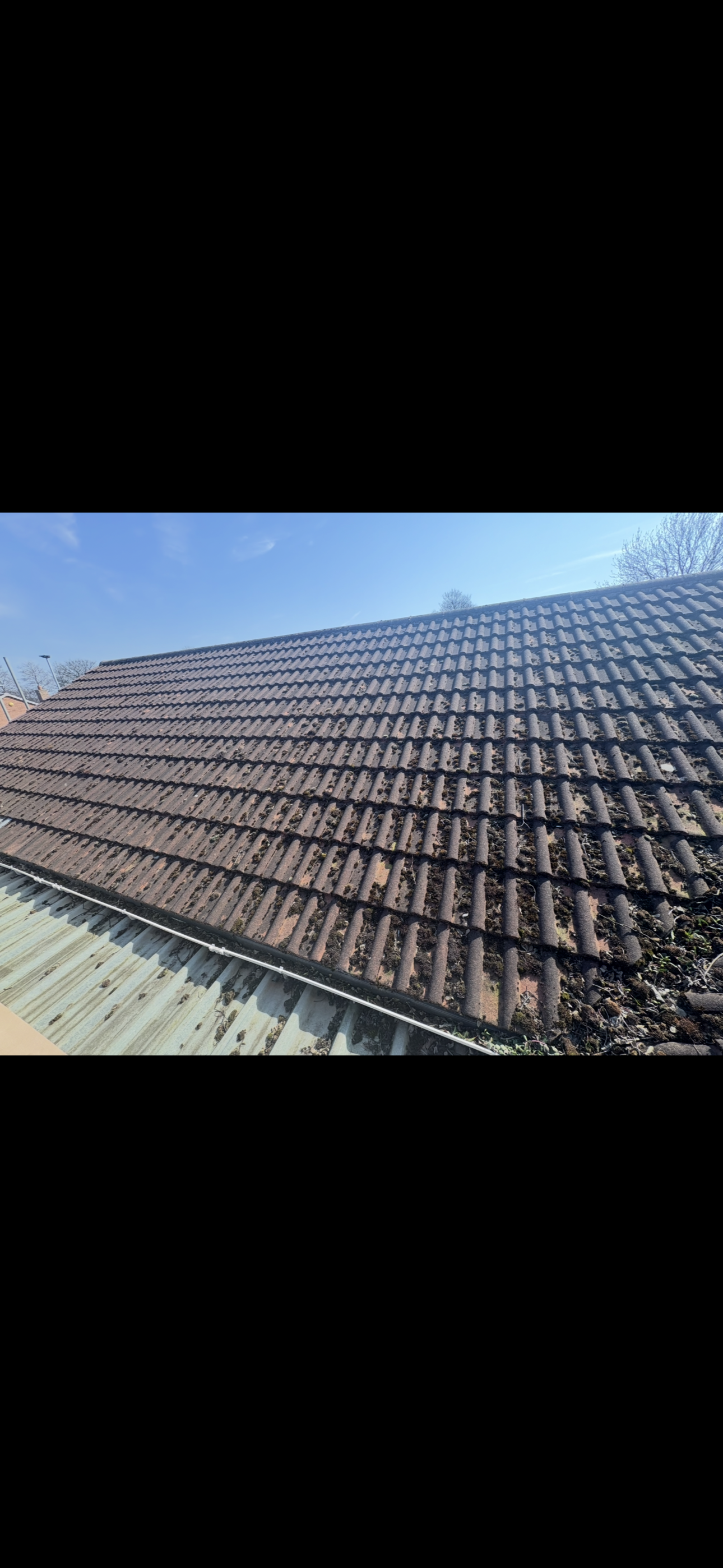 Roof valley between two slopes with tiles cut in either side