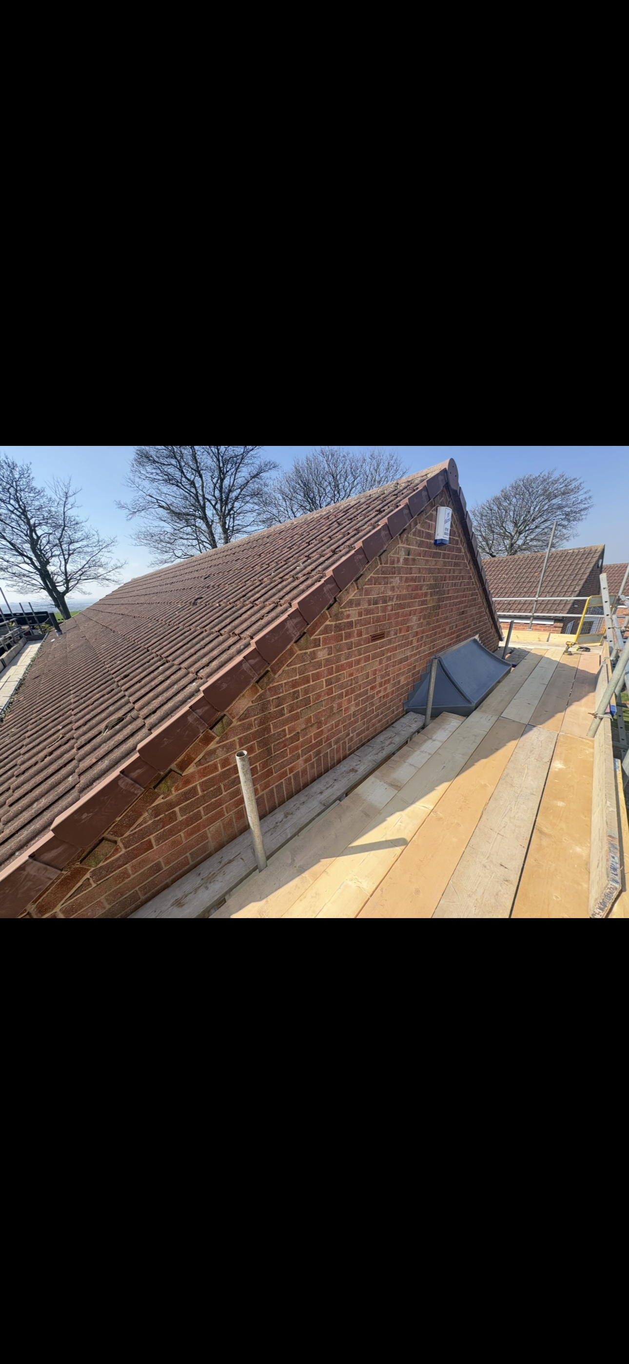 Rear roof slope of a house with the gutter line below