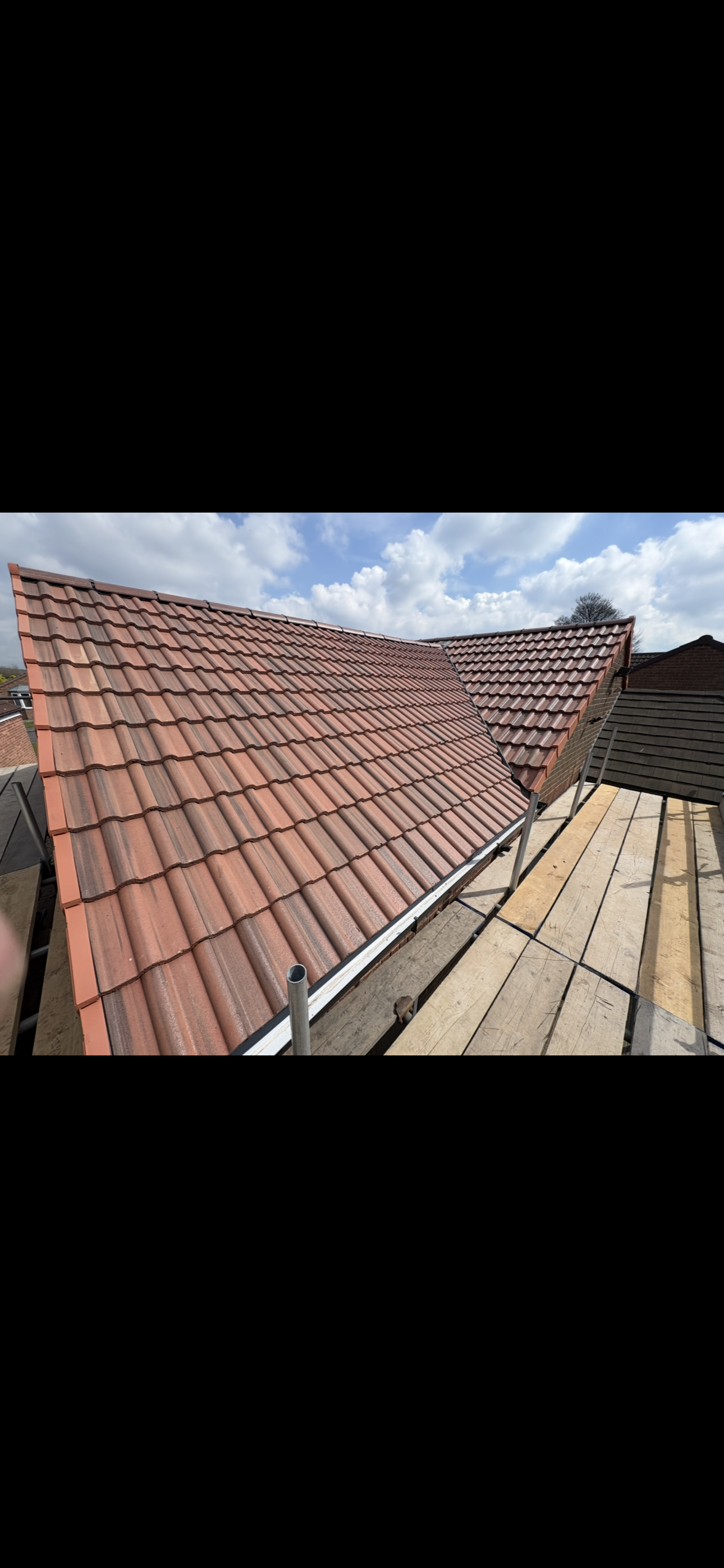 Roof tiles laid out across a slope during work