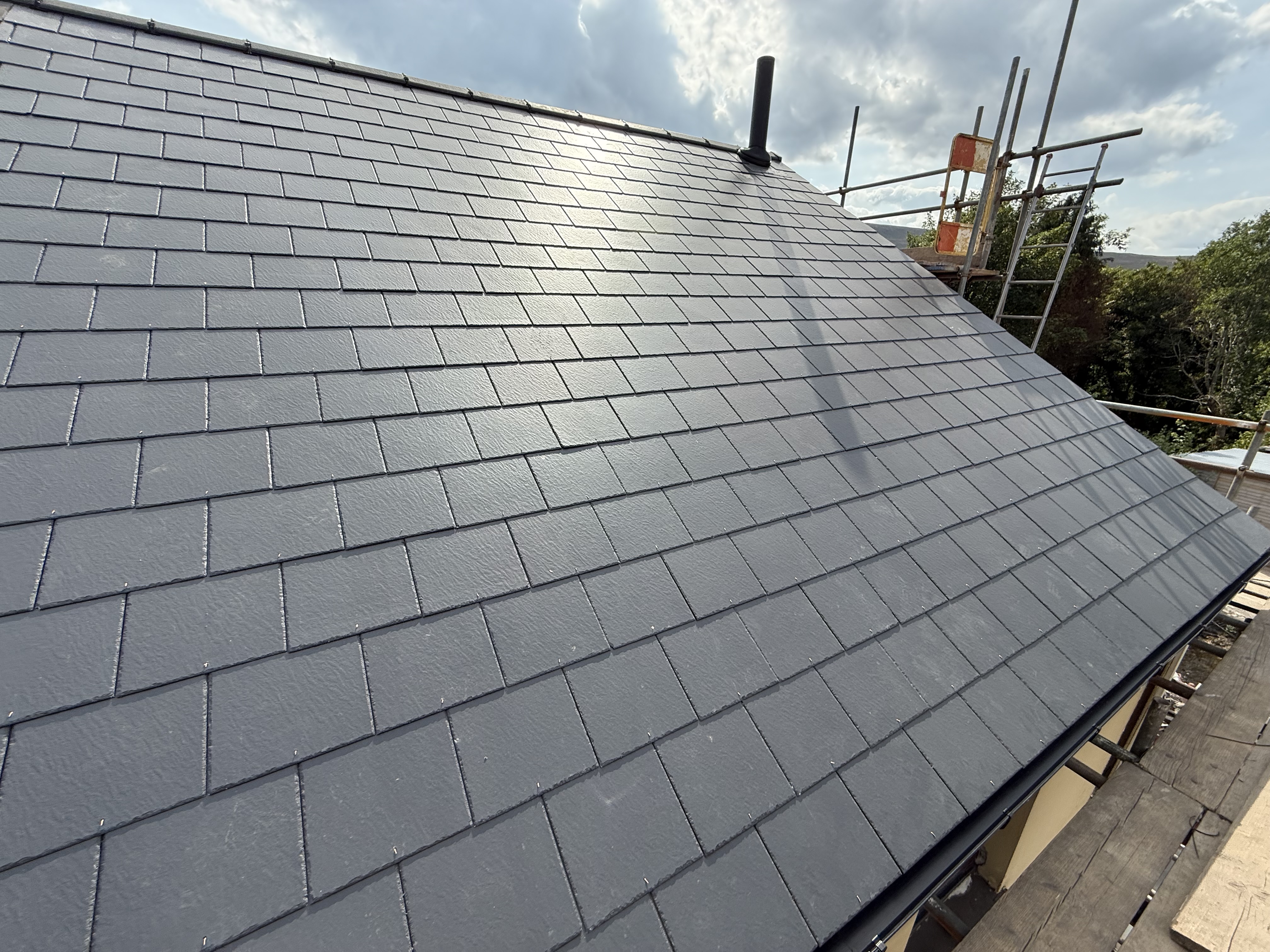 Roofing work on a residential property, photographed from ground level