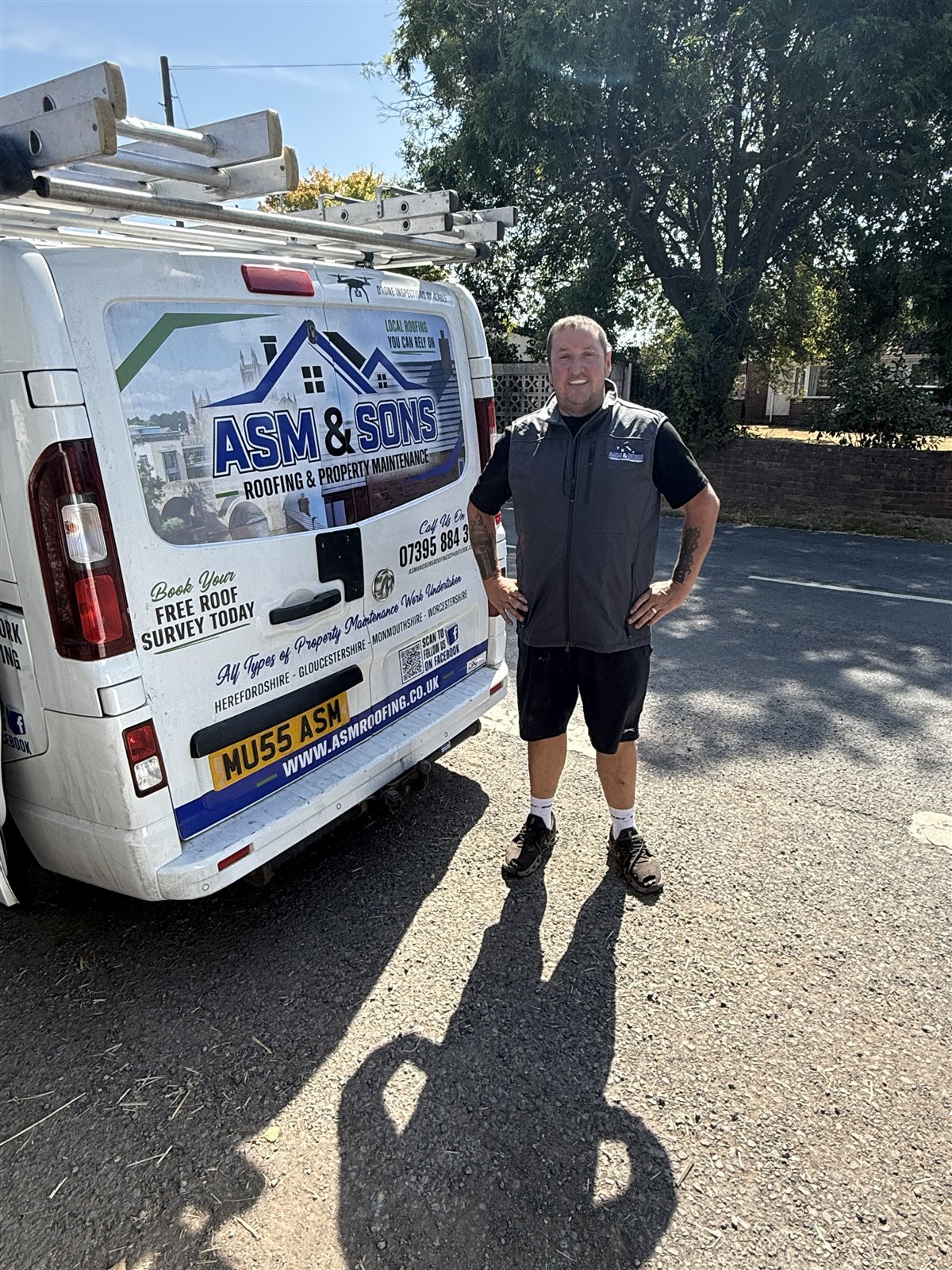 Aaron Murray of ASM & Sons Roofing standing beside his branded van in Hereford