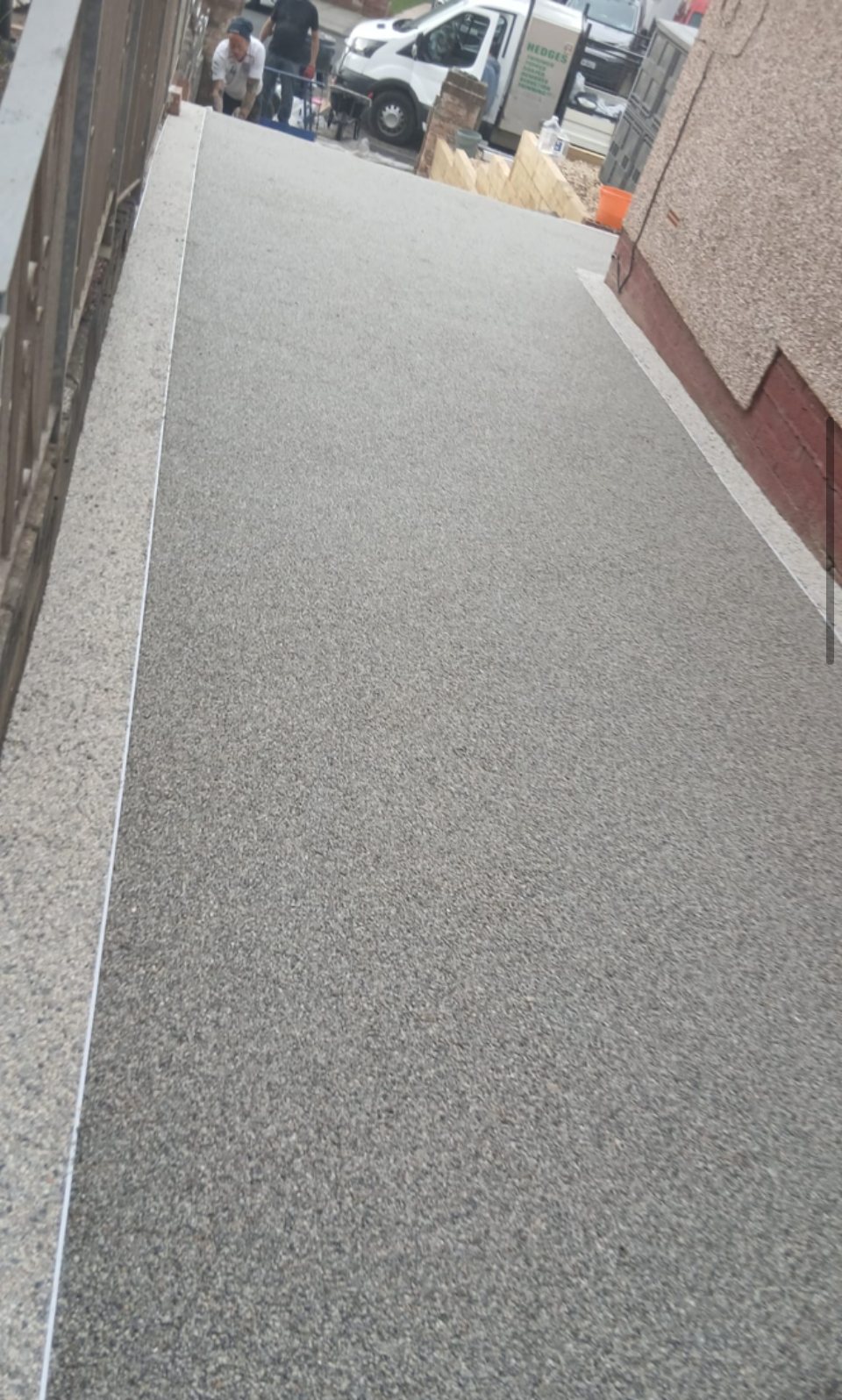 Driveway surface finished up to the edging by Atlas